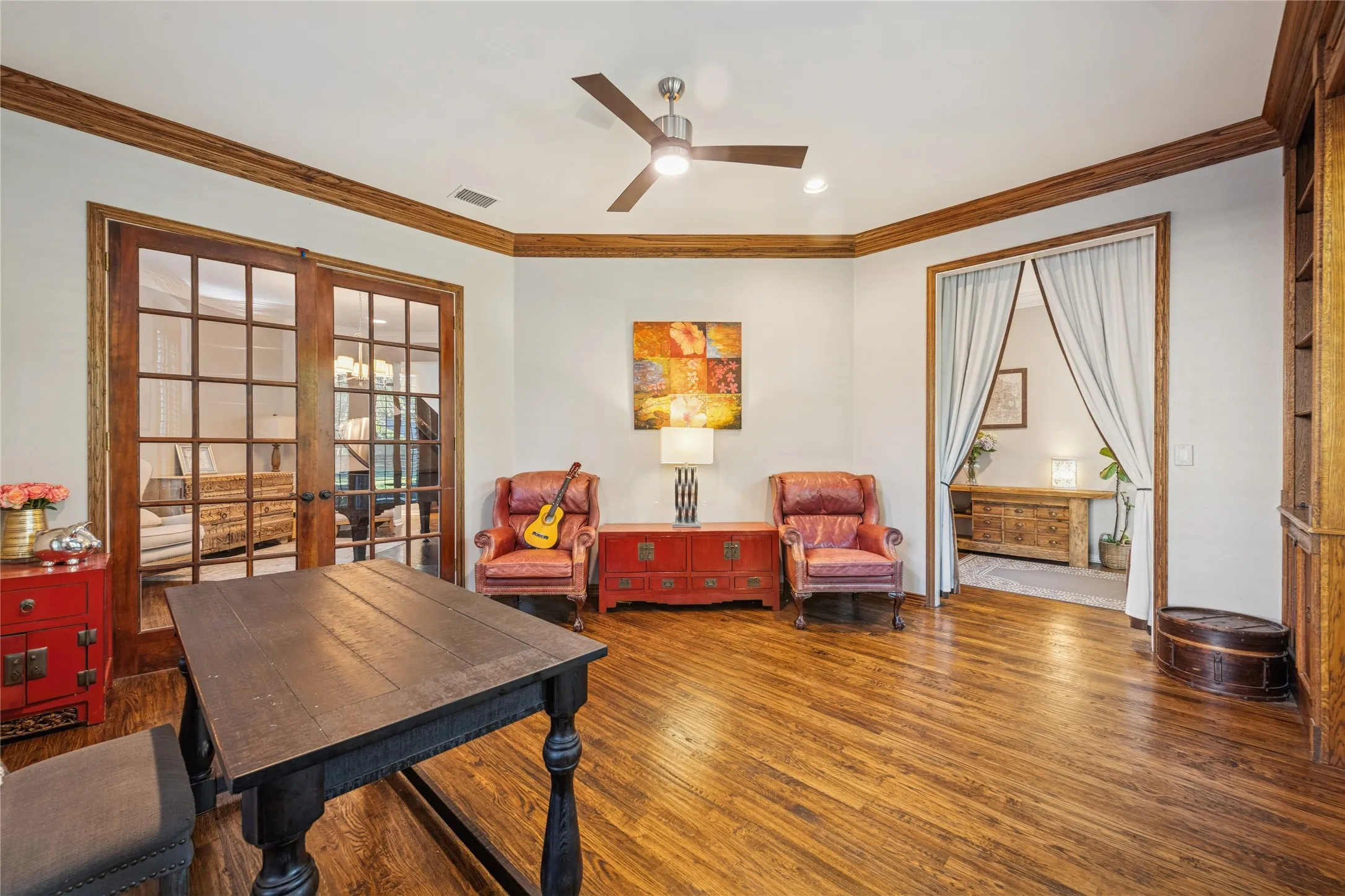 Office area with french doors, ornamental molding, hardwood / wood-style flooring, and a ceiling fan