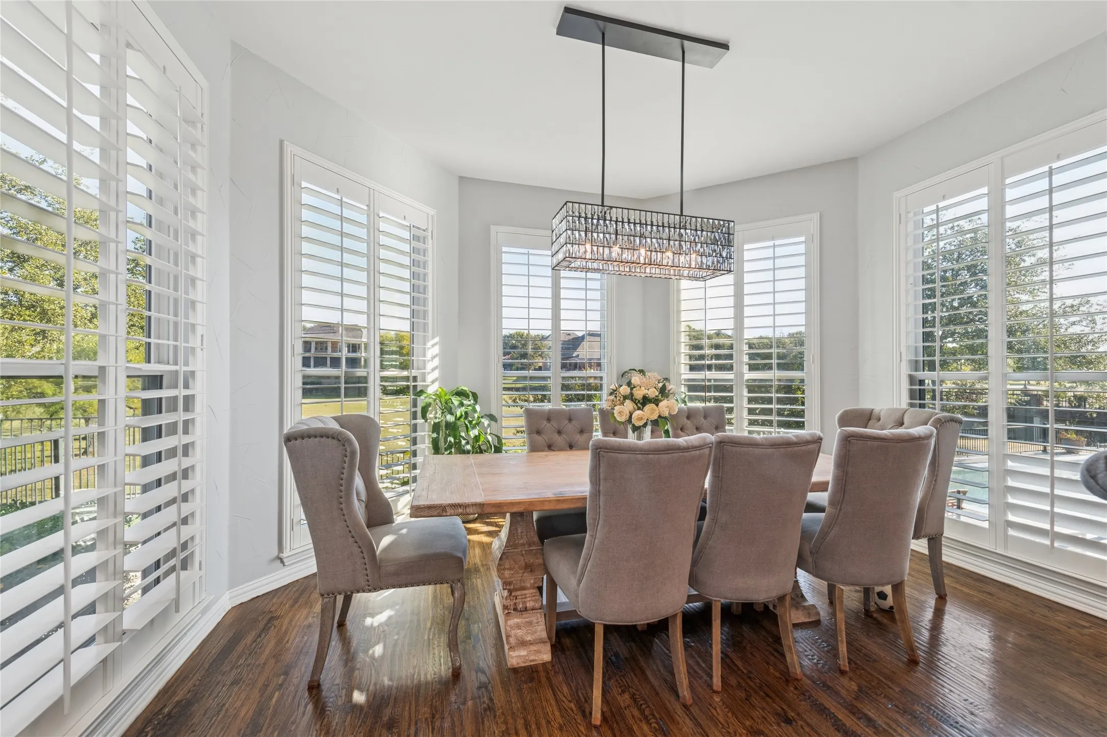 Dining space featuring dark wood-style floors and baseboards