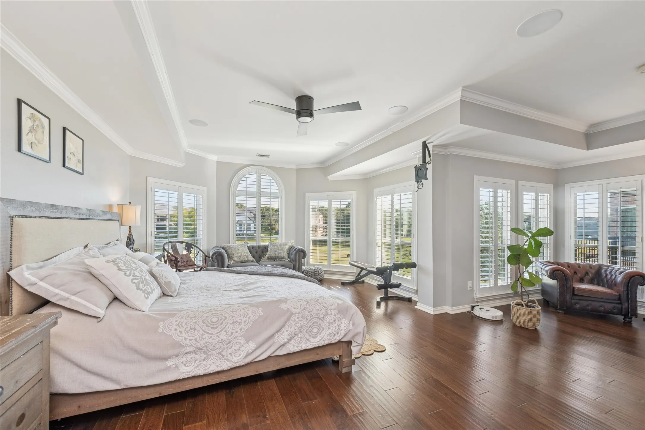 Bedroom with hardwood / wood-style flooring, ceiling fan, and crown molding