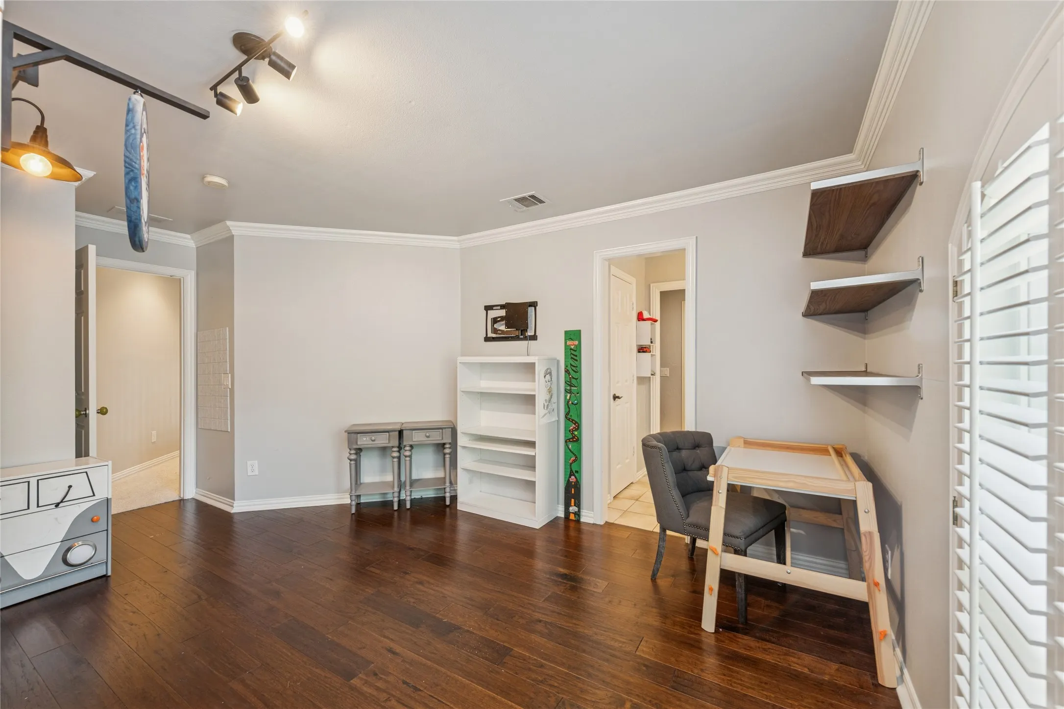 Office area with dark wood finished floors and crown molding