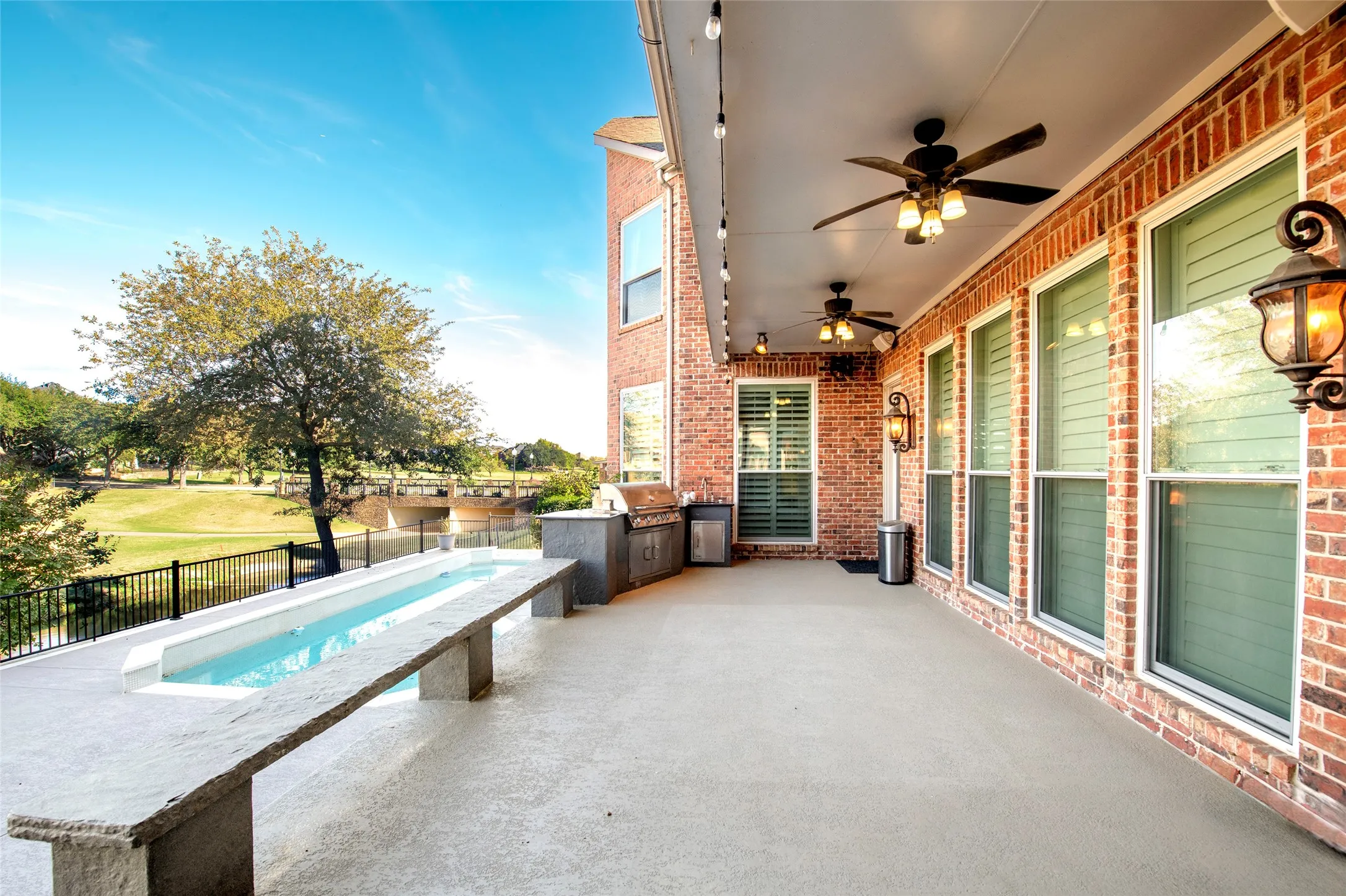 Fenced backyard featuring area for grilling, a patio, and a ceiling fan