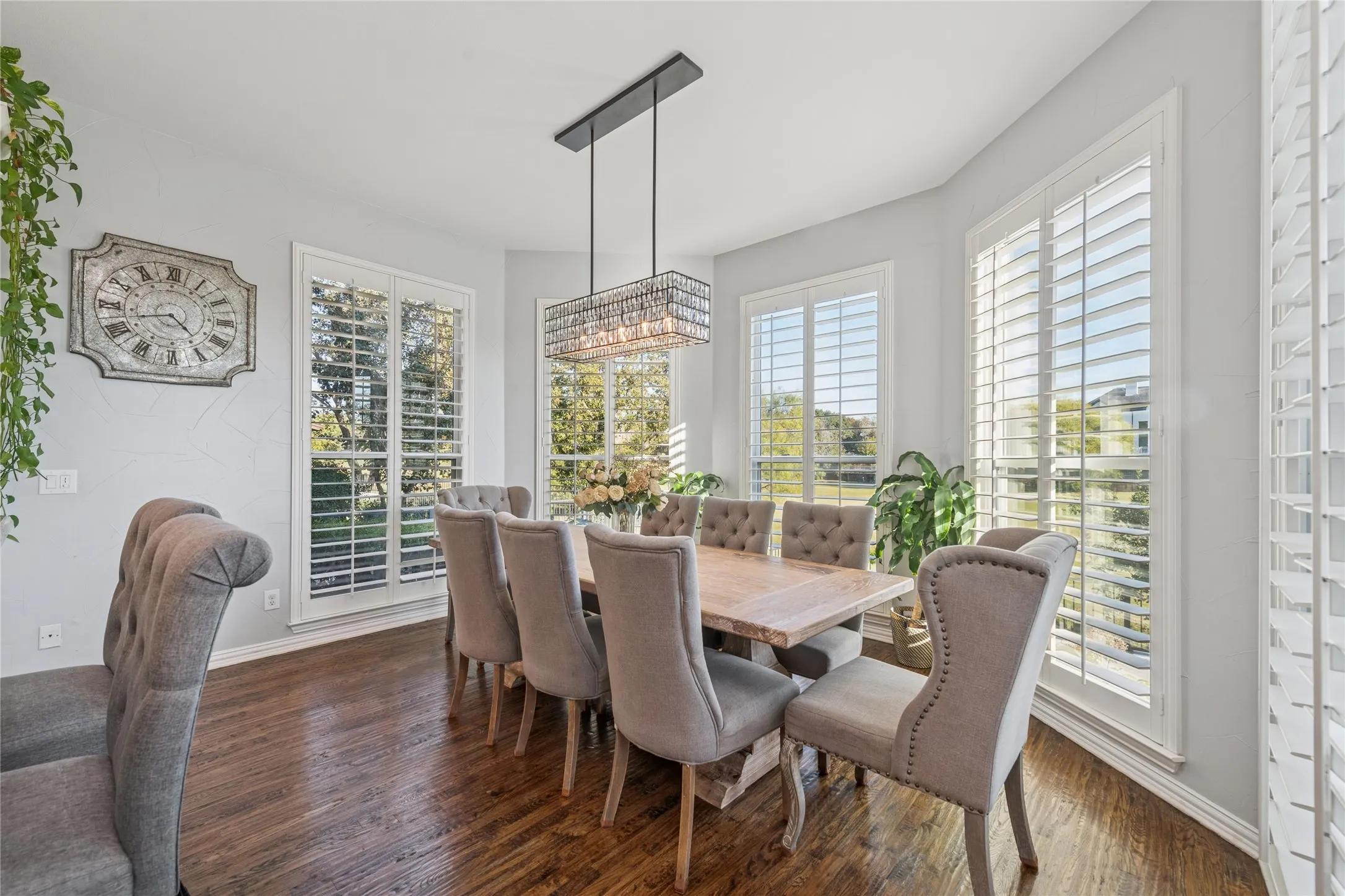 Dining space featuring healthy amount of natural light and dark wood-style flooring