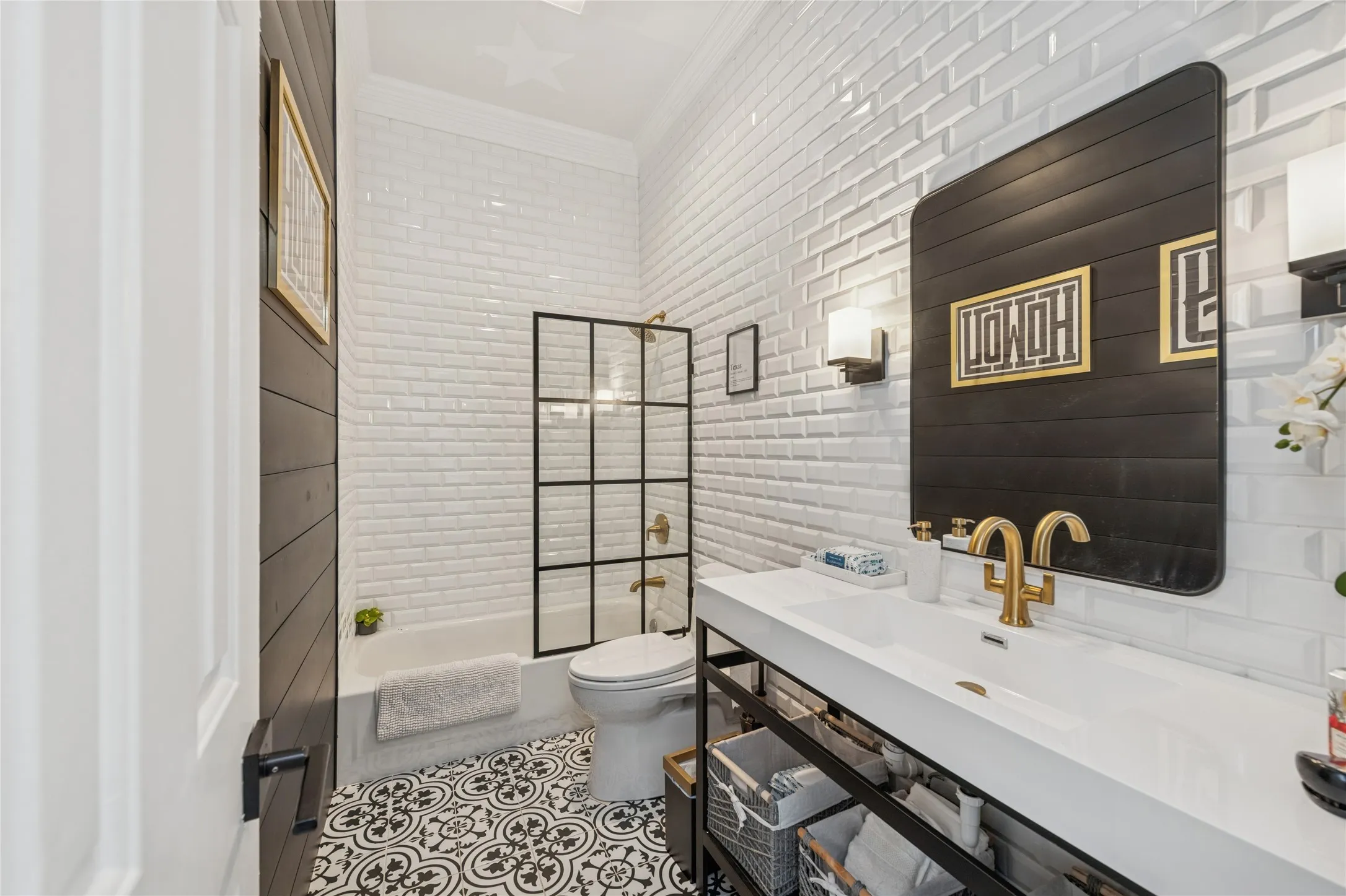 Full bath featuring ornamental molding, tile walls, bathing tub / shower combination, vanity, and tile patterned floors