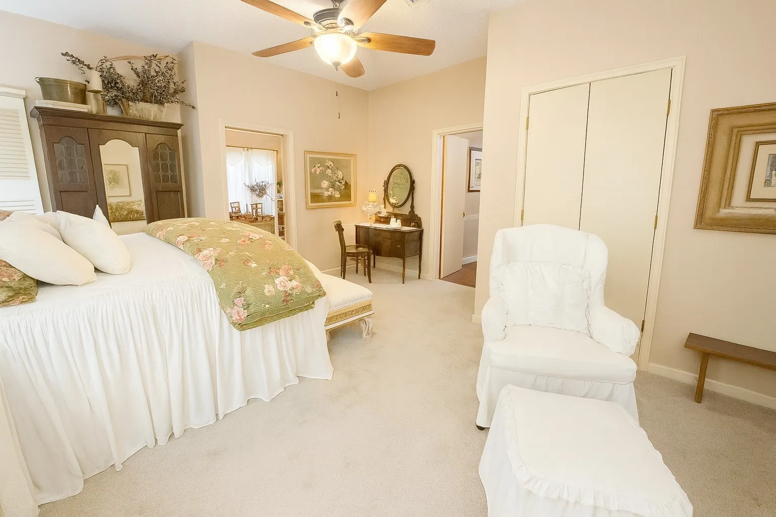 Carpeted bedroom with ceiling fan and baseboards