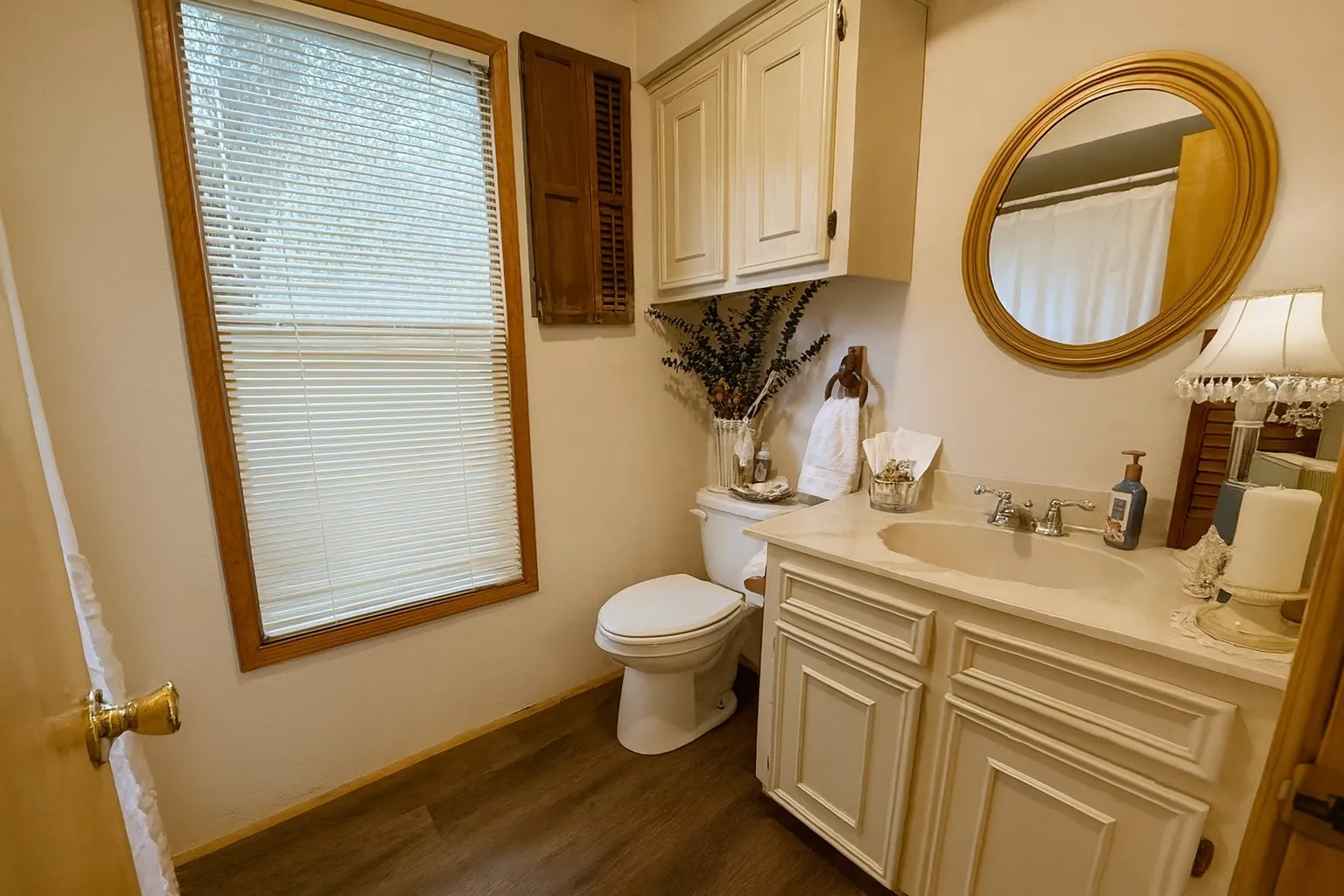Bathroom with vanity, a shower with curtain, and dark wood-style flooring