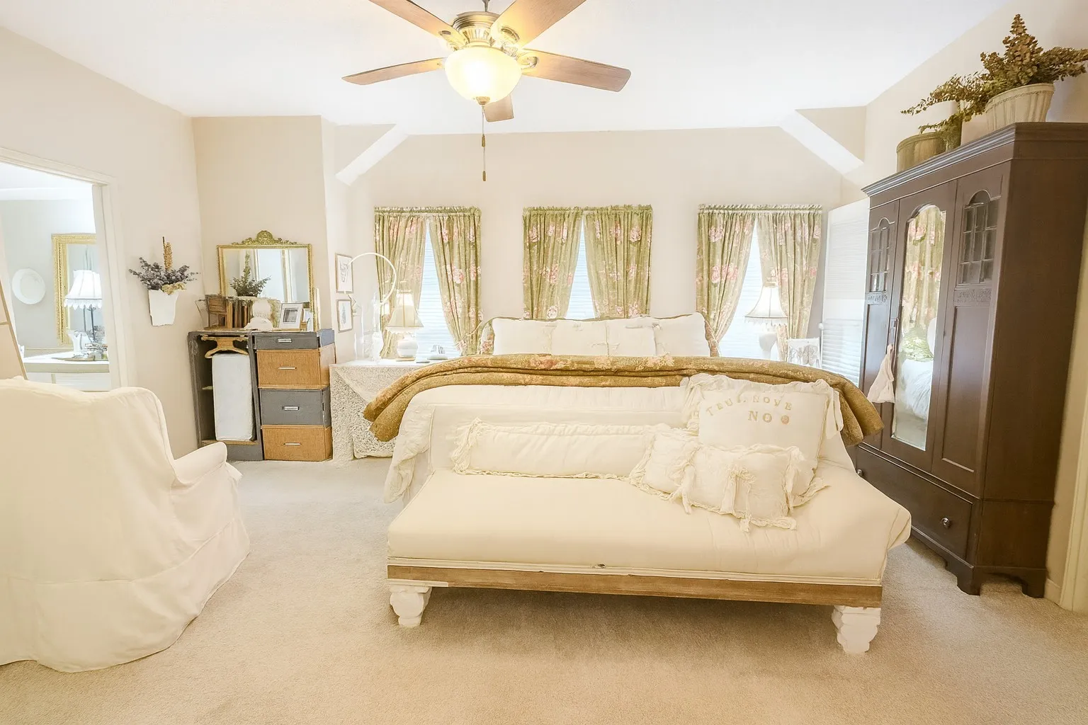 Carpeted bedroom featuring multiple windows and ceiling fan