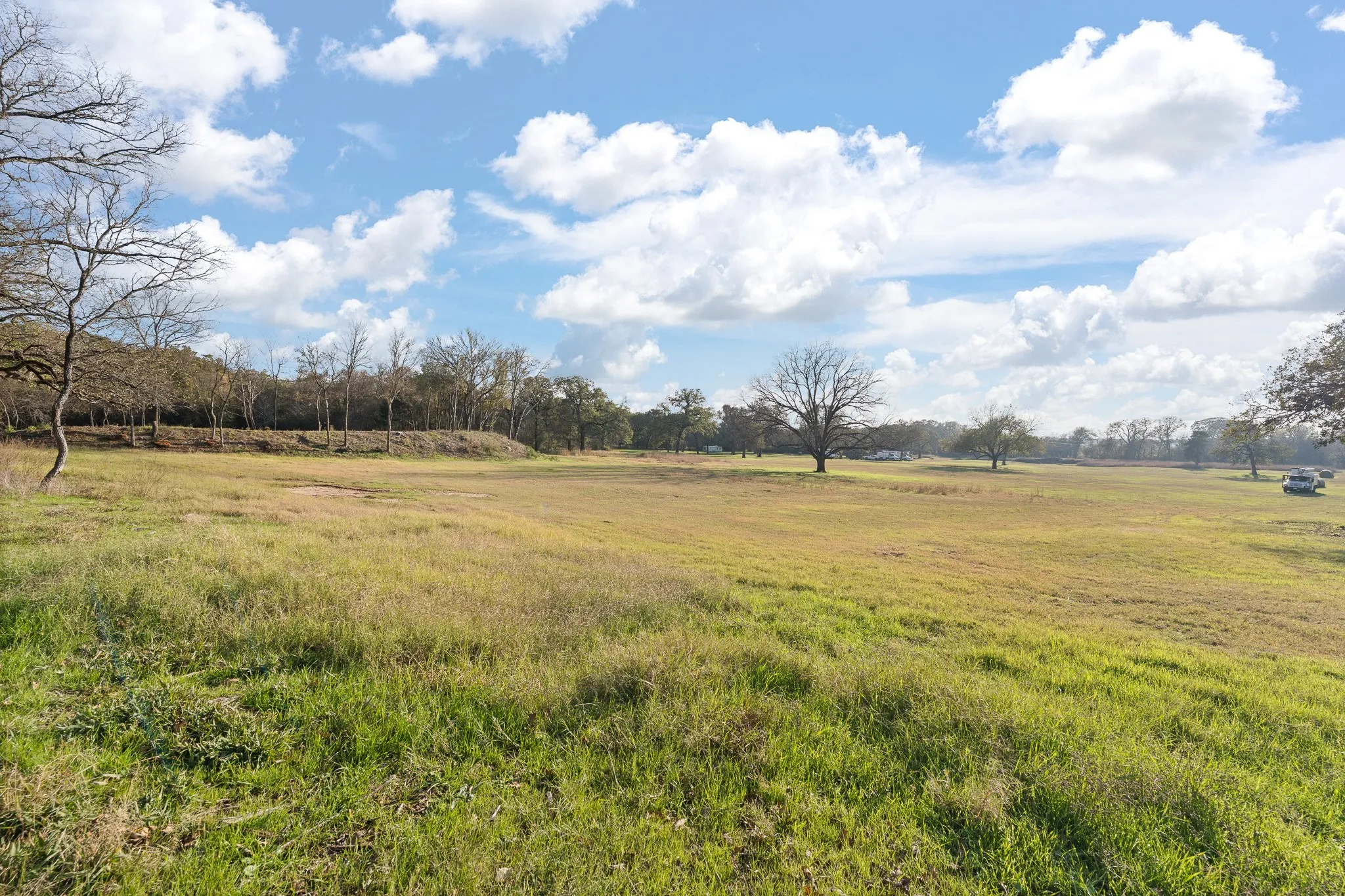 View of green lawn with a rural view