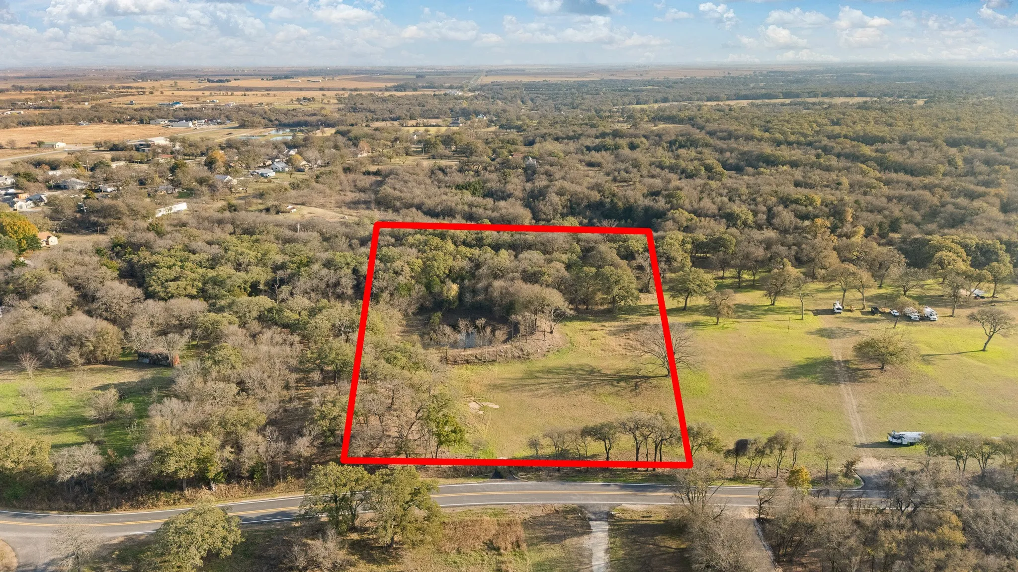 Aerial view of property's location with property boundaries highlighted and a forest