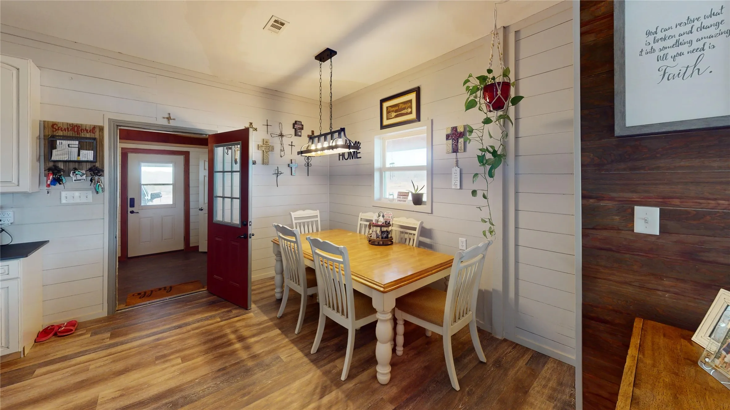 Dining space featuring wooden walls and light wood finished floors
