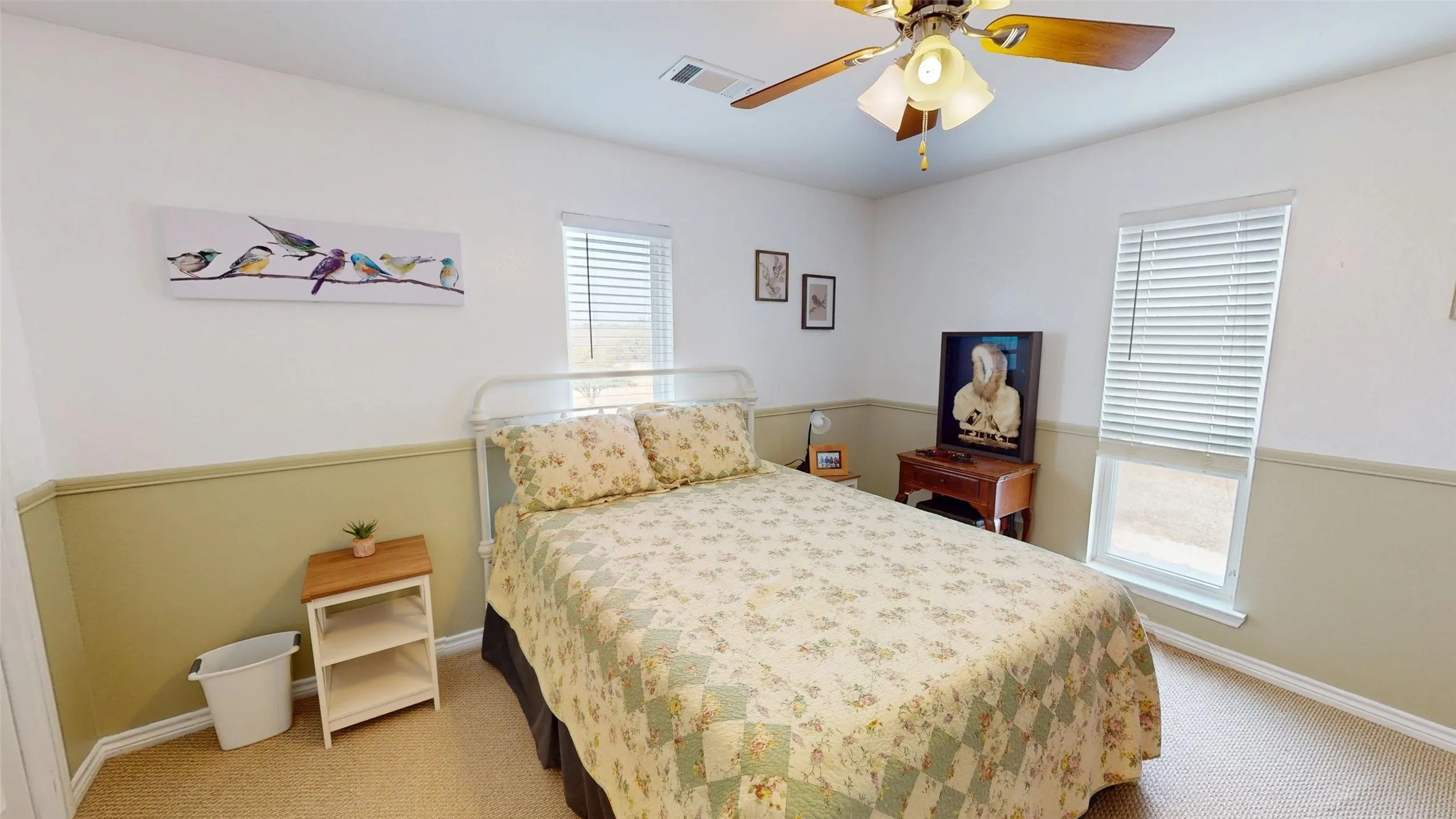 Bedroom featuring light carpet and a ceiling fan