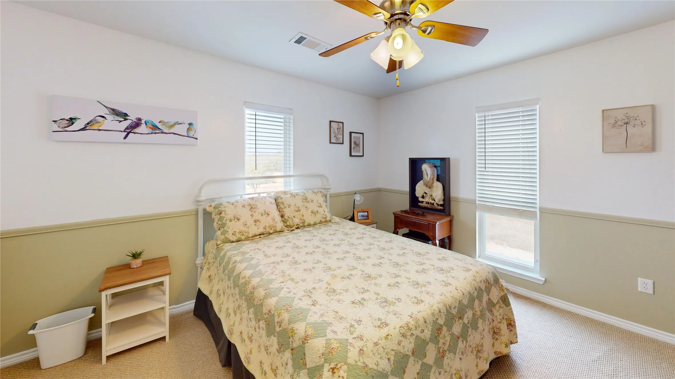 Bedroom with light carpet and a ceiling fan