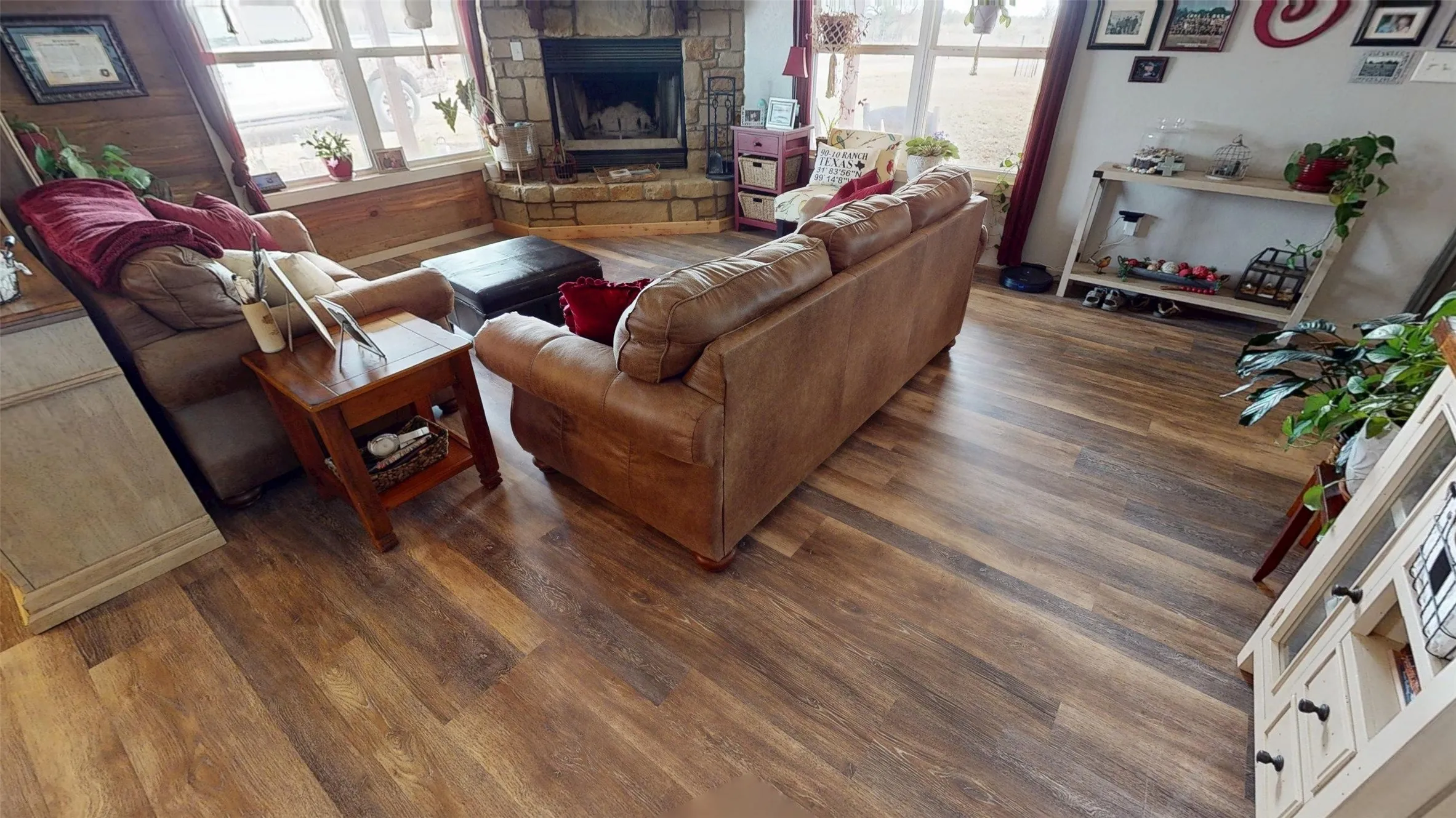 Living room with plenty of natural light, dark wood-style flooring, and a fireplace