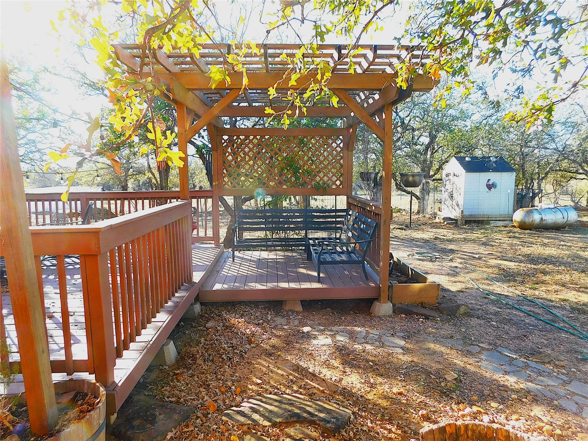 Wooden terrace featuring a storage shed