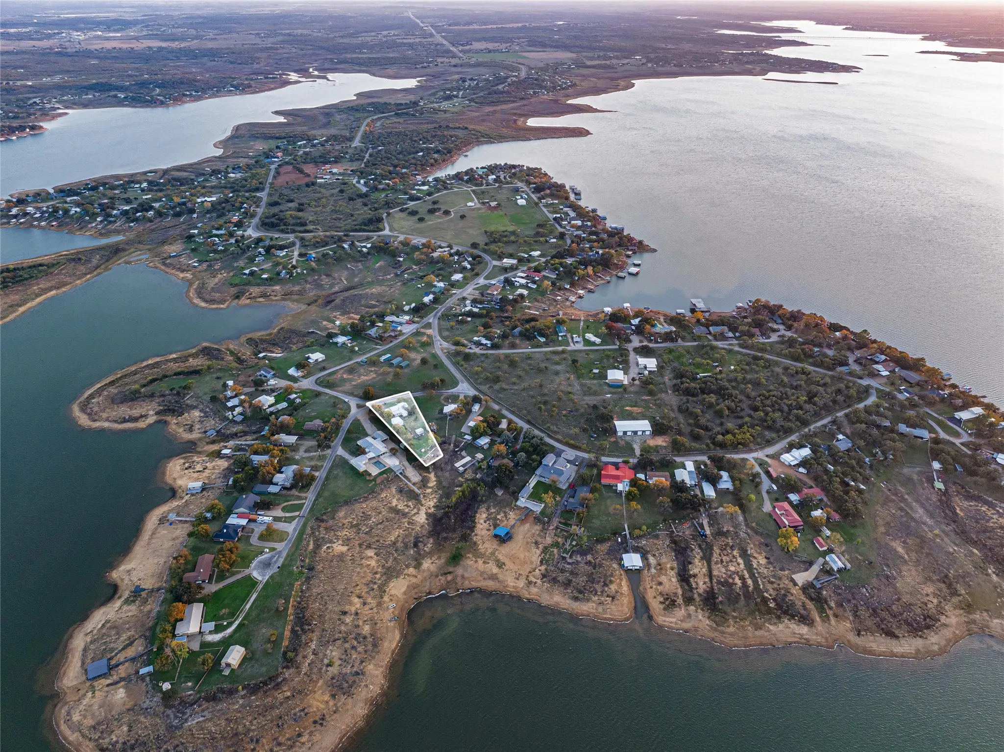 Aerial view of property and surrounding area featuring a large body of water