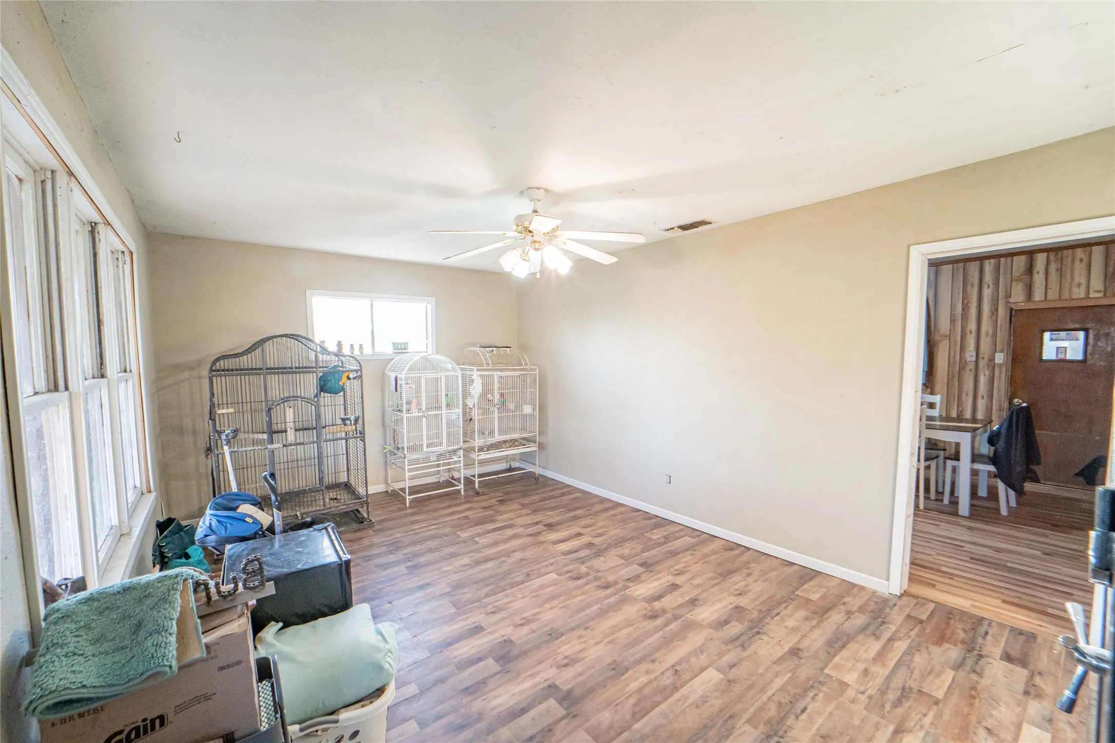 Living room with light wood-style floors and ceiling fan