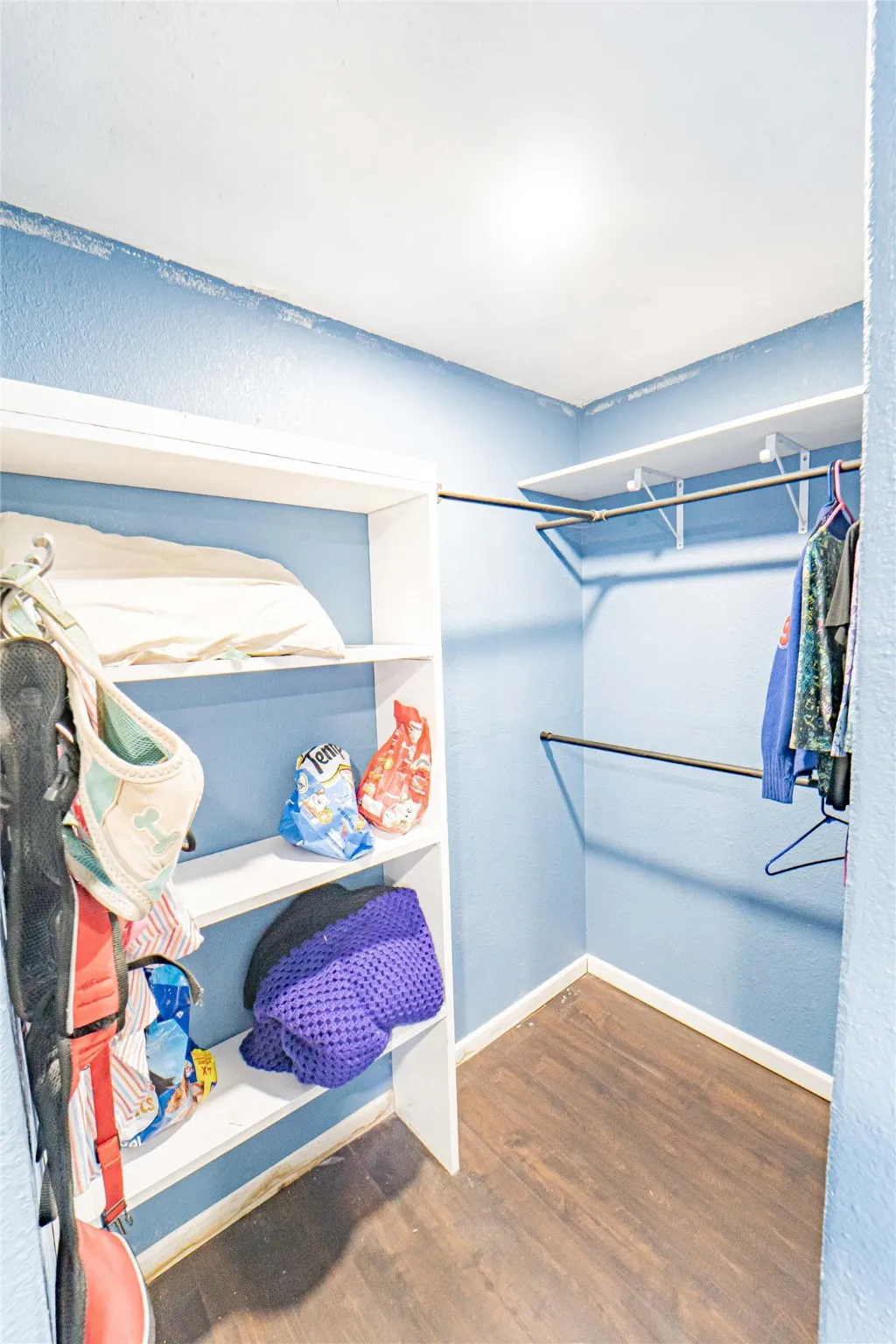 Walk in closet featuring dark wood finished floors
