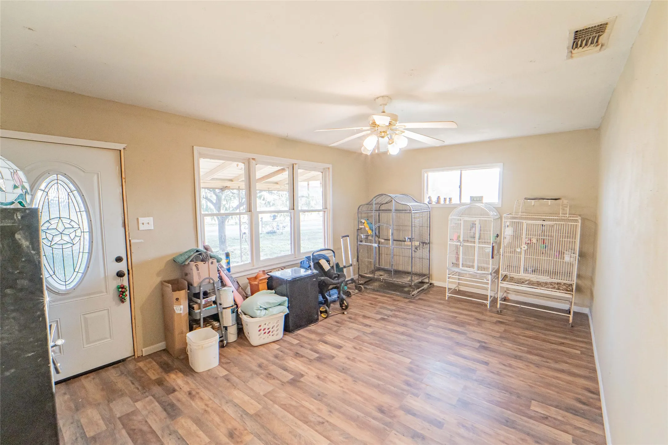 Foyer with a ceiling fan and wood finished floors