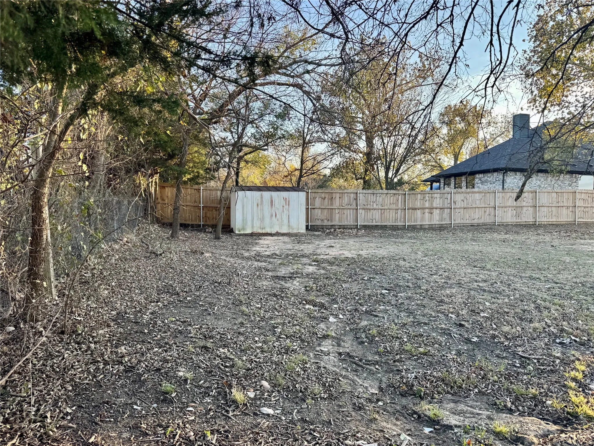 Back of property.  Chain link fence and neighbors wood fence.