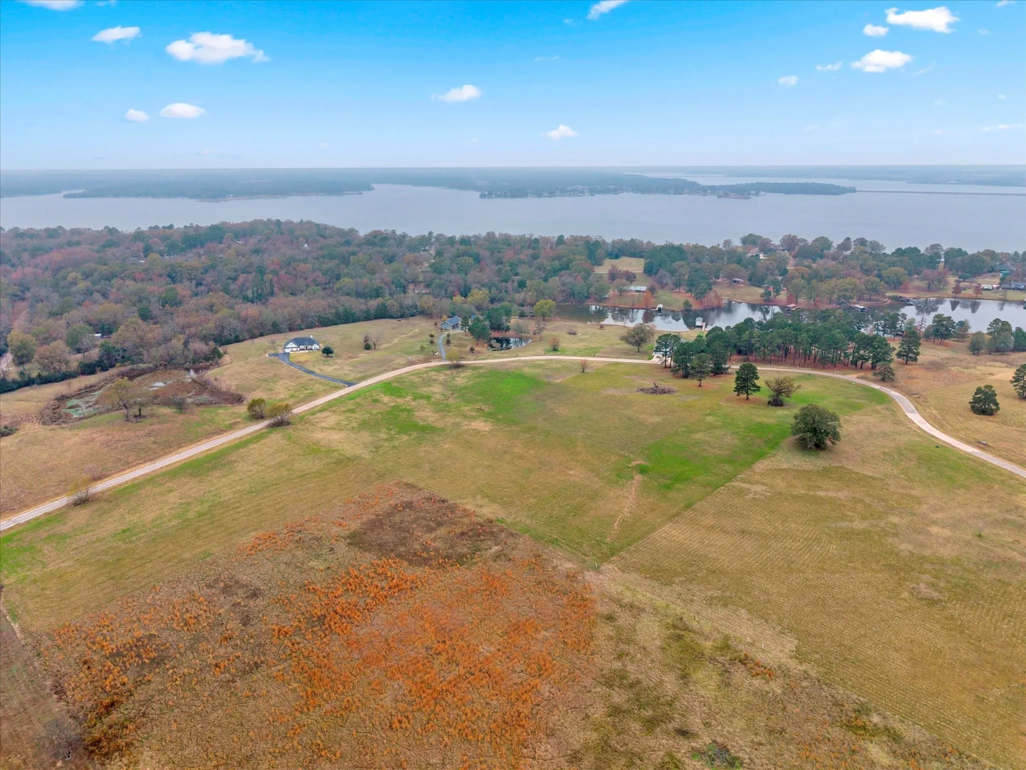 Aerial overview of property's location with a nearby body of water and rural landscape