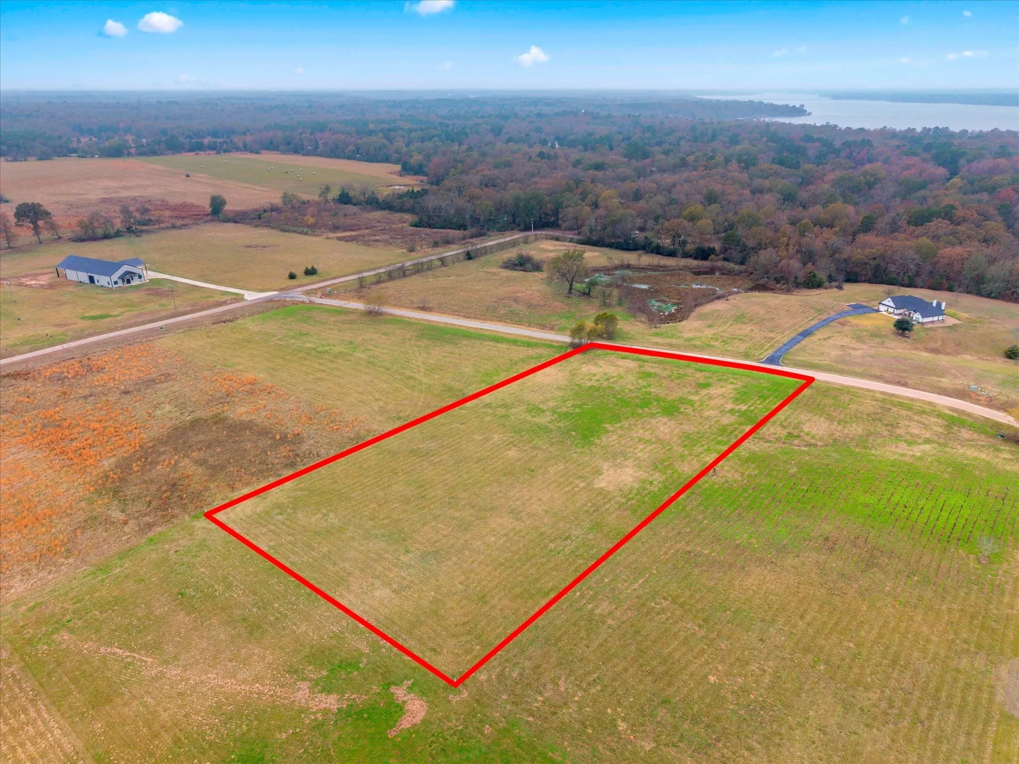 Overview of rural landscape with property boundaries highlighted and a large body of water