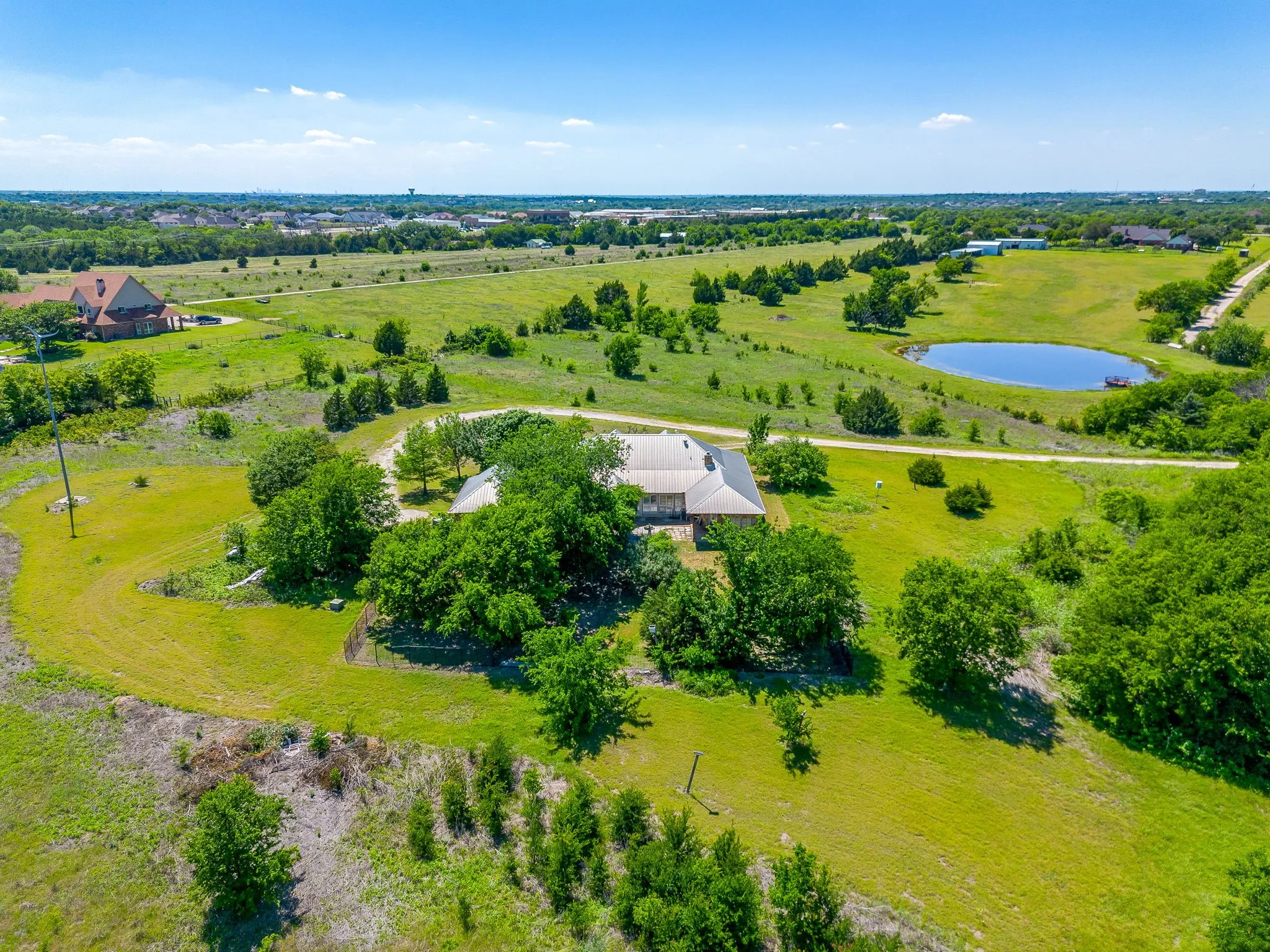 View over back of home with fenced yard