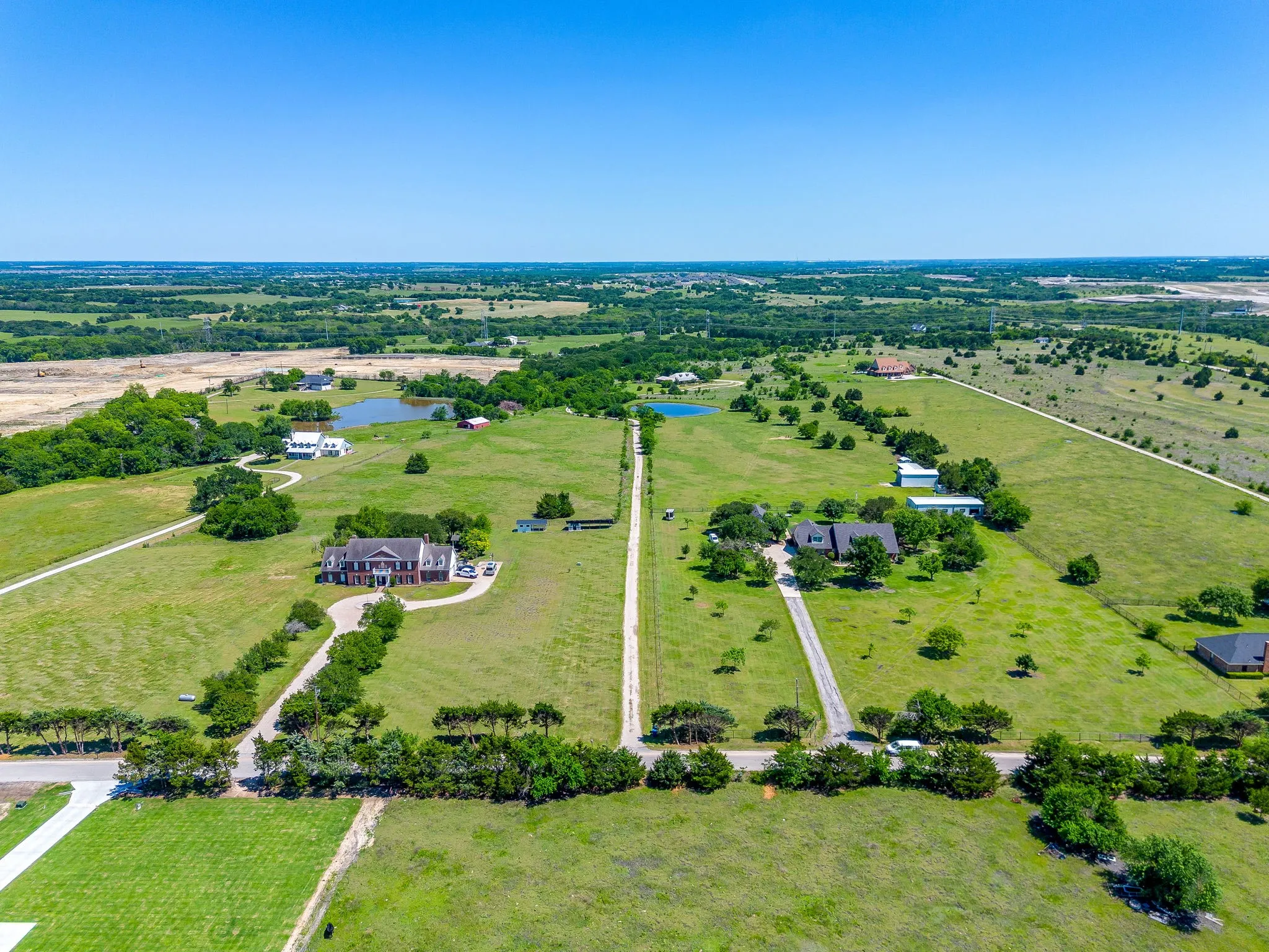 View of land from the north showing 1/4 mile access road back to house