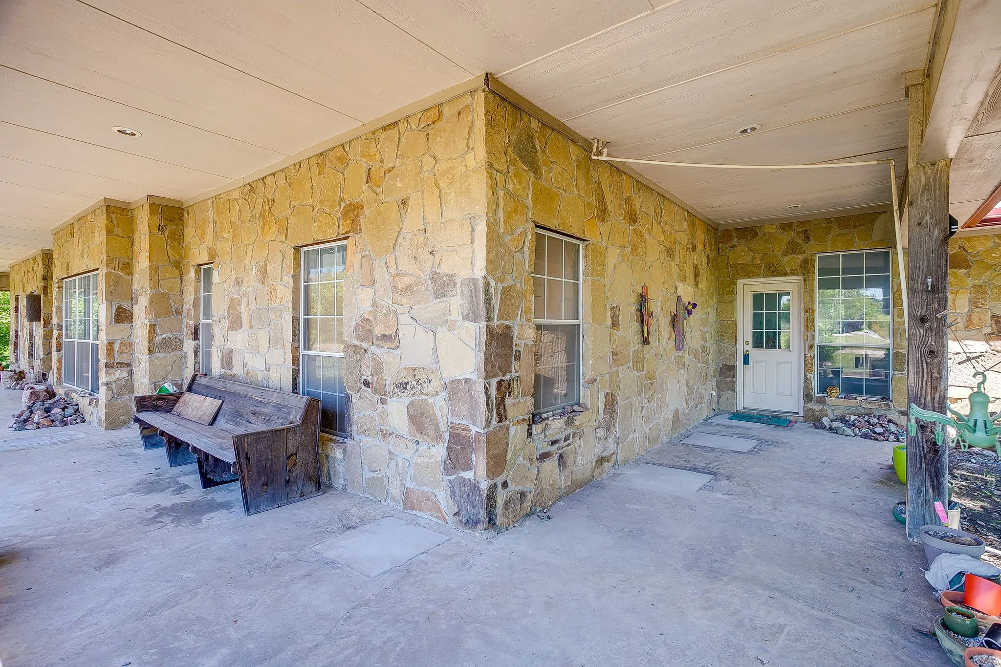 Large covered patio wraps around front of home
