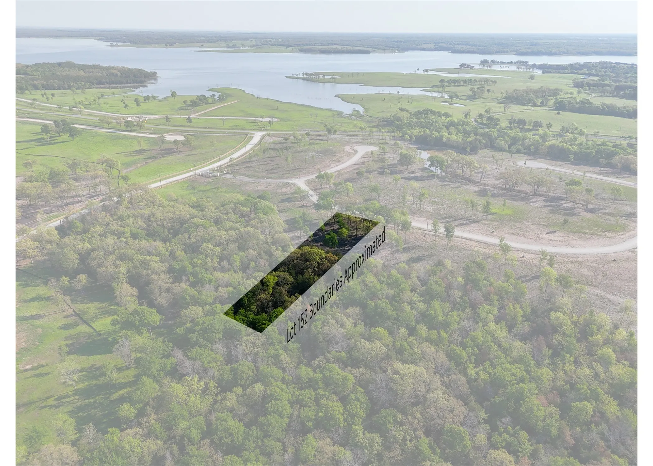 Aerial view featuring a forest view and a water view