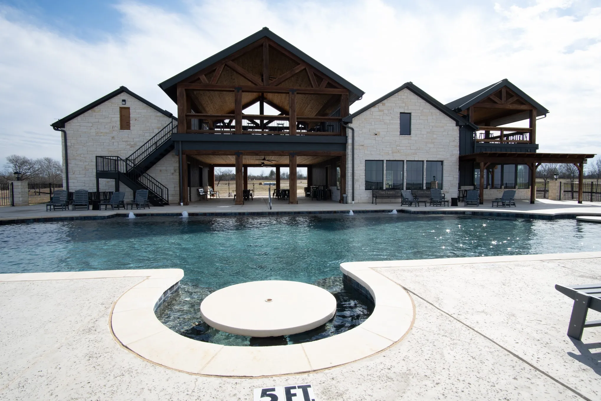 Community pool featuring stairs and a patio