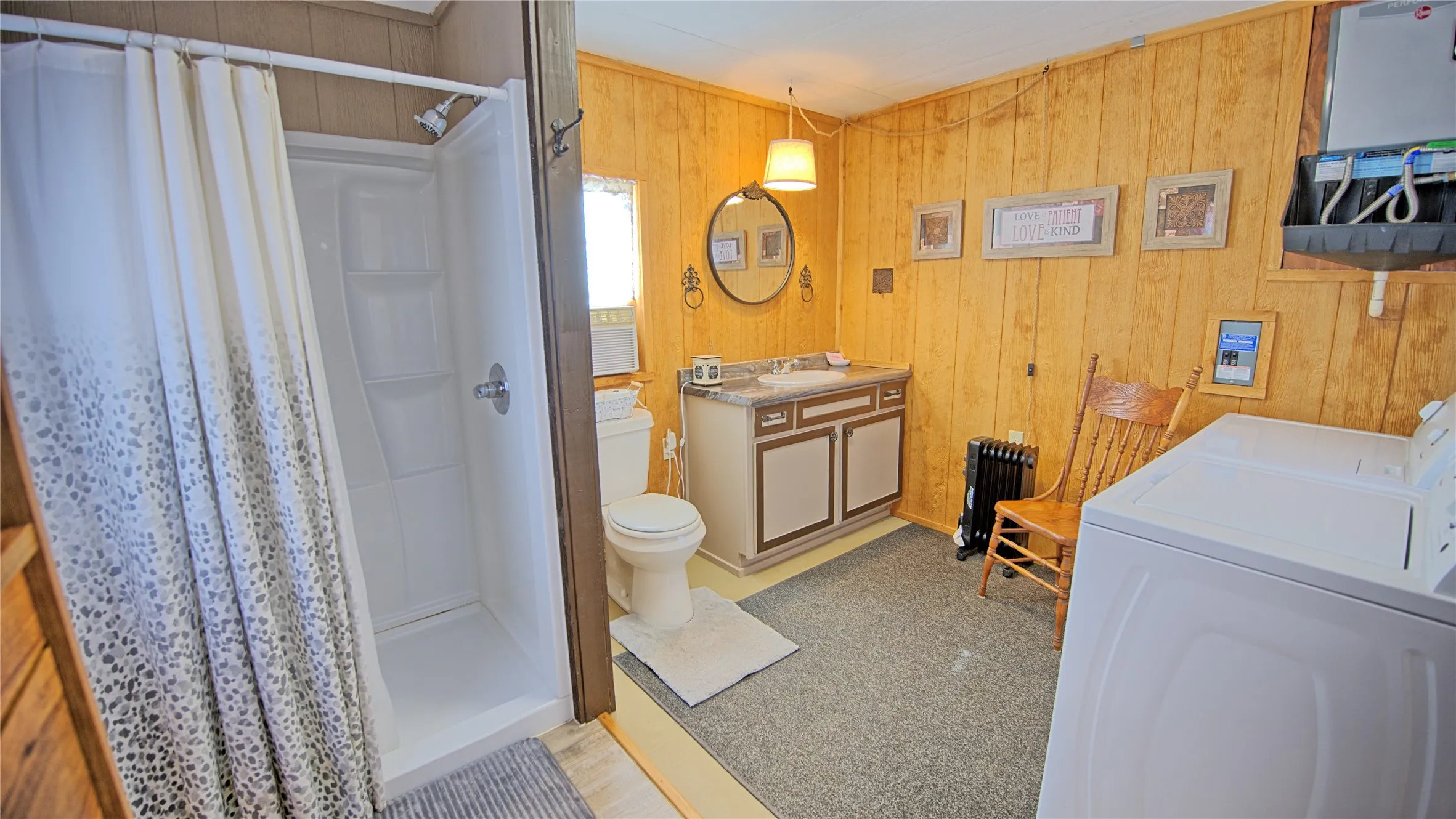 Separate Bath House features shower and laundry area.  electric oil heater on site.