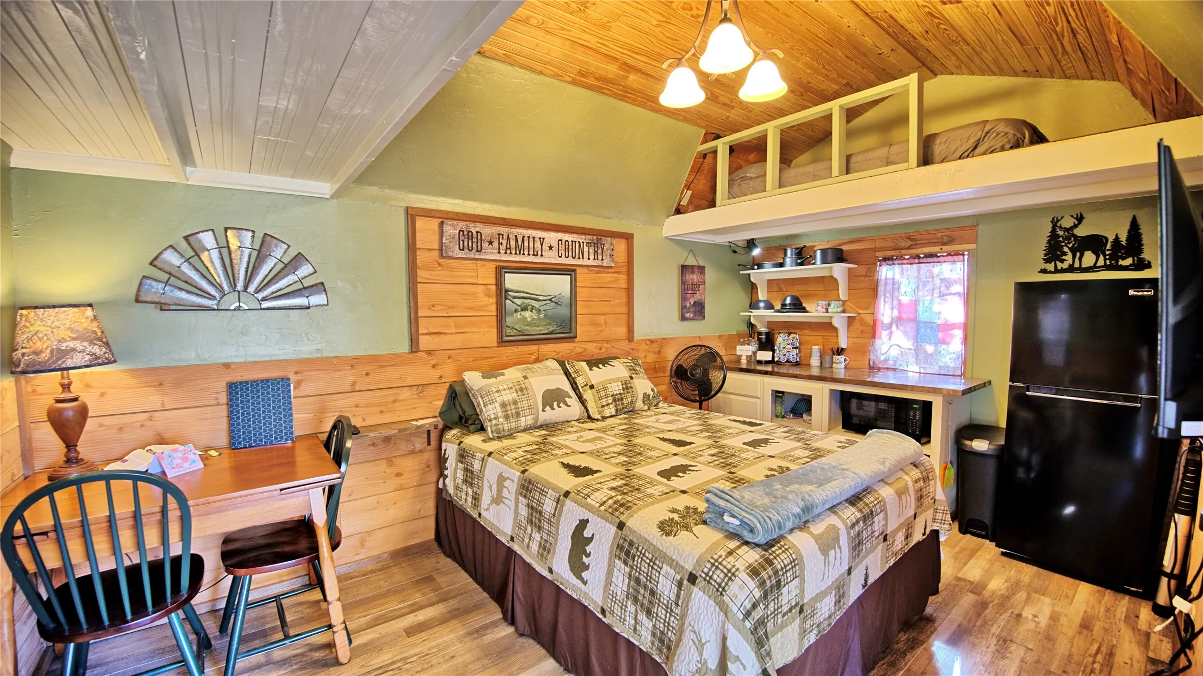 Inside of Richard's Haven features Queen Bed, refrigerator, loft area