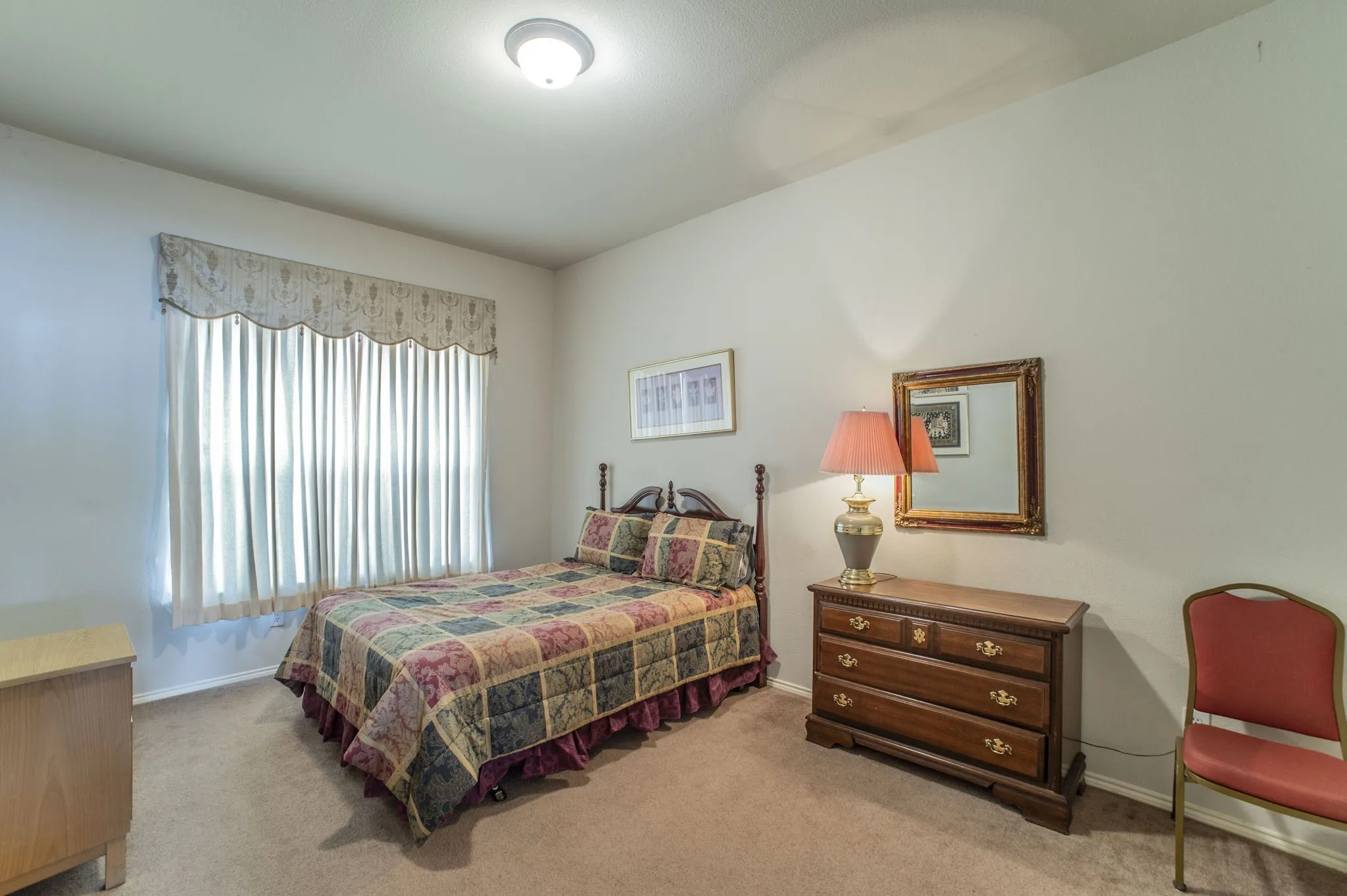 Carpeted bedroom with baseboards