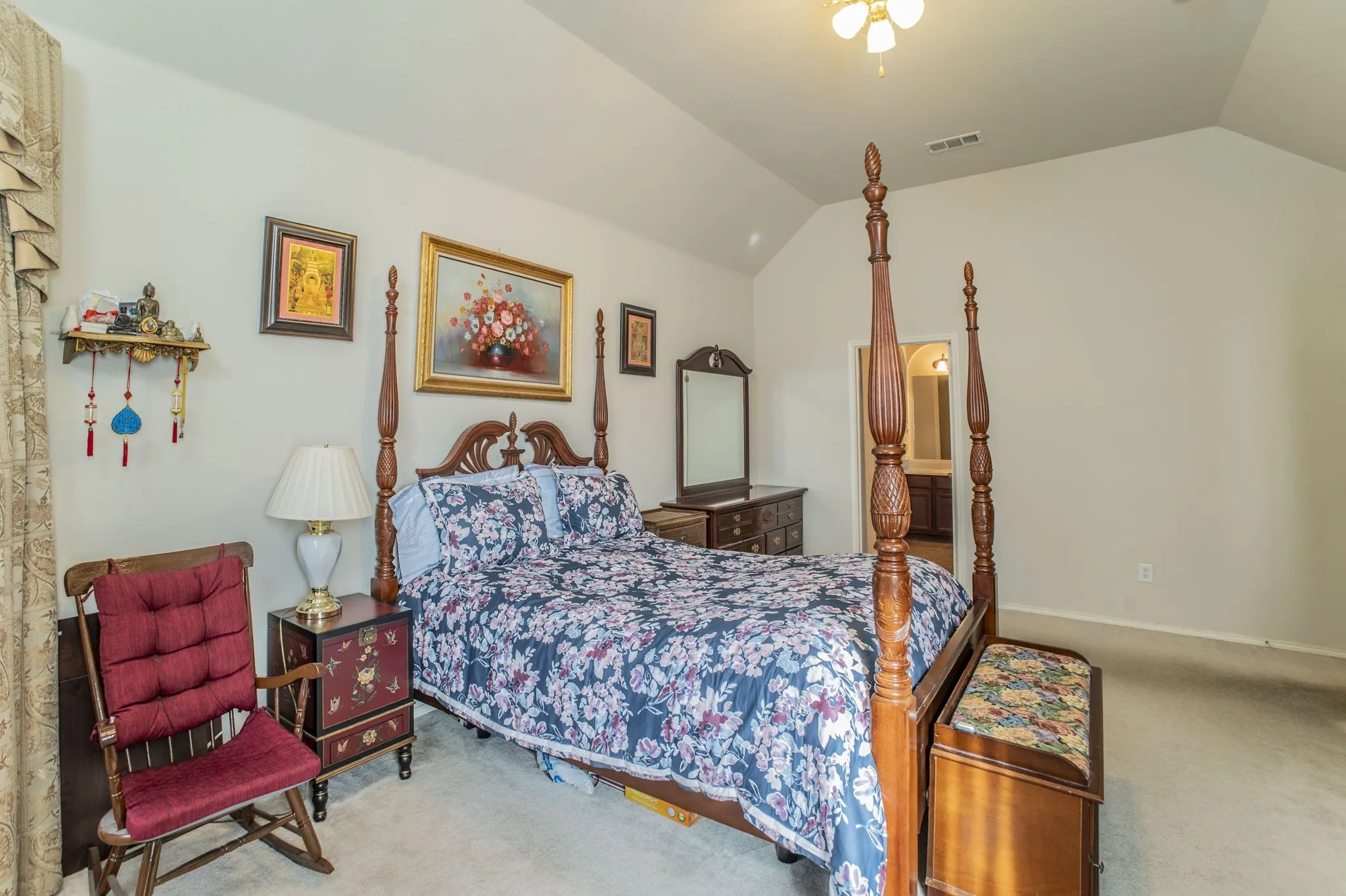 Carpeted bedroom with vaulted ceiling and ensuite bath