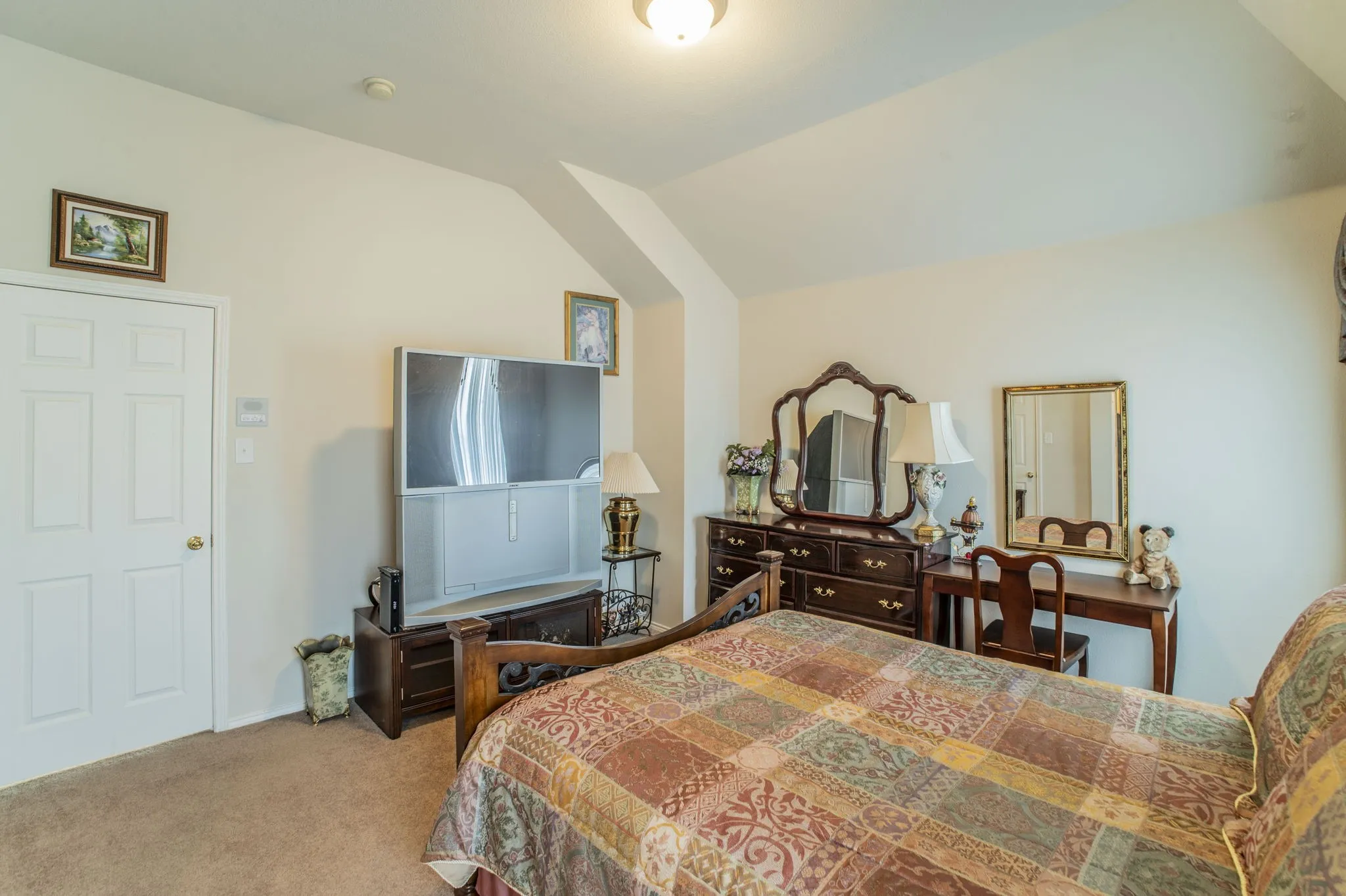 Bedroom featuring vaulted ceiling and light colored carpet