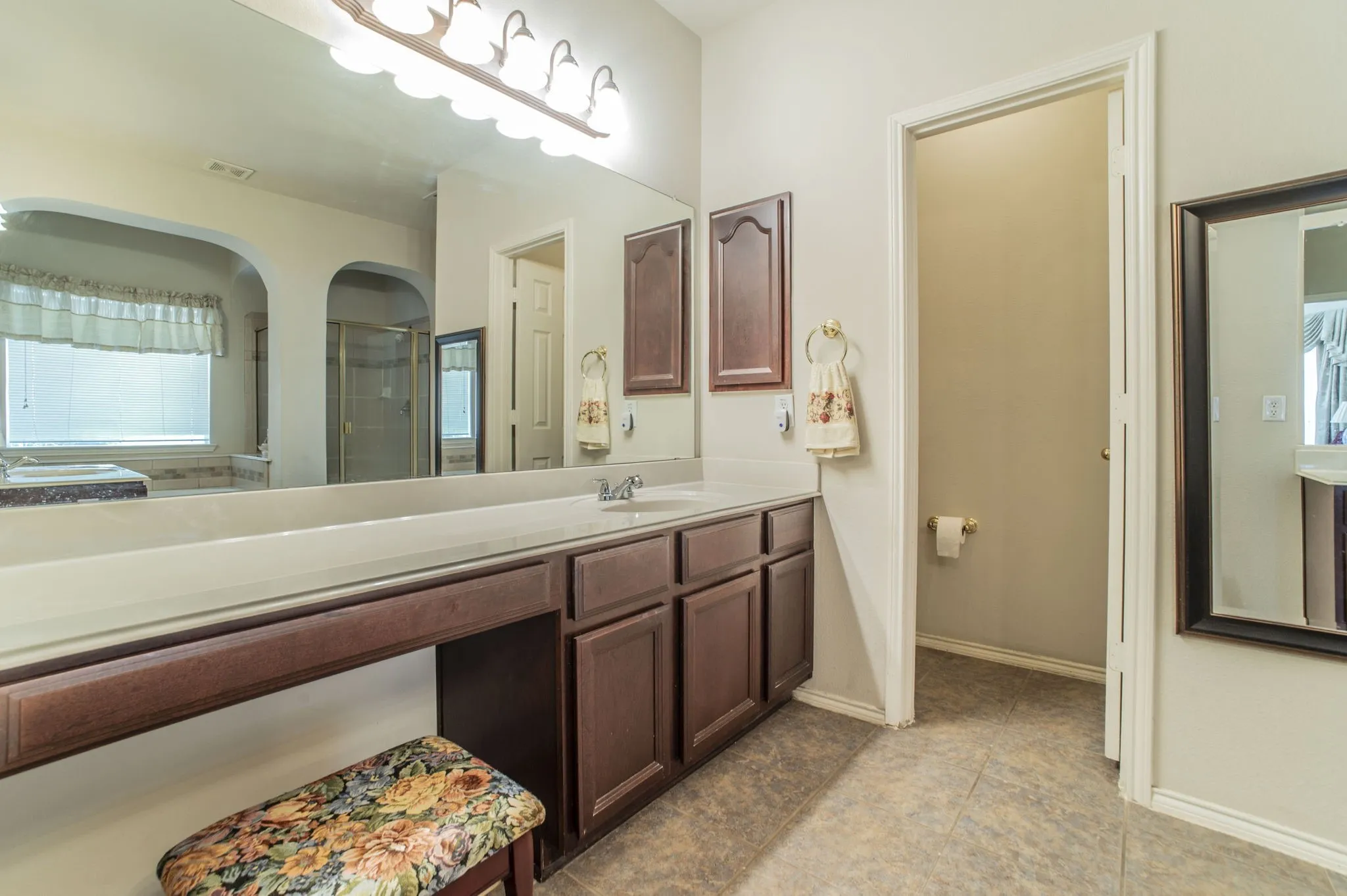 Full bath with vanity, healthy amount of natural light, and a shower stall