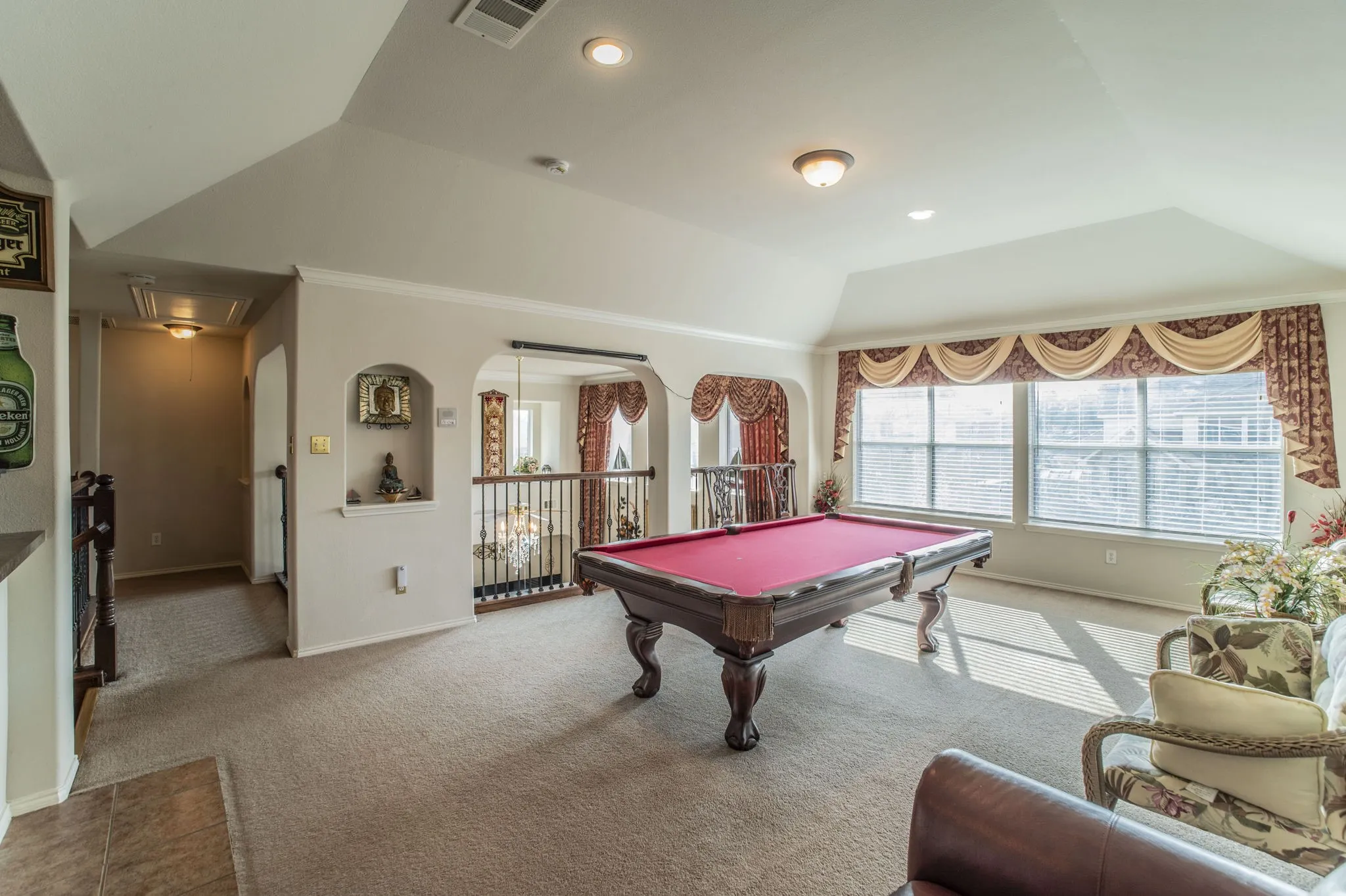 Playroom featuring attic access, billiards table, healthy amount of natural light, carpet flooring, and lofted ceiling