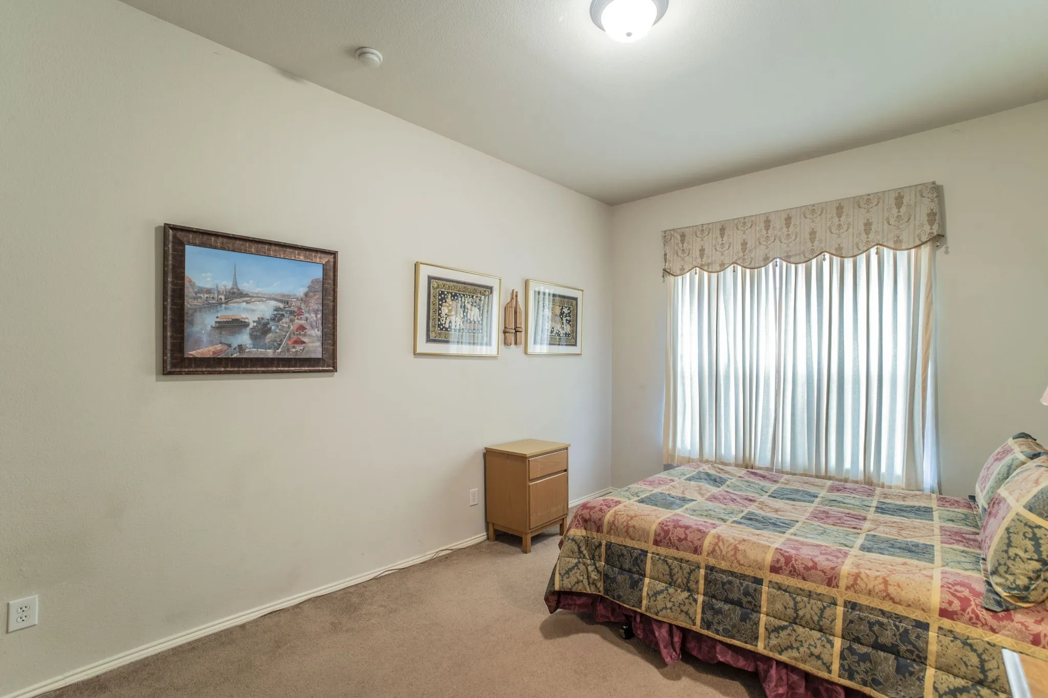 Bedroom featuring carpet flooring and baseboards