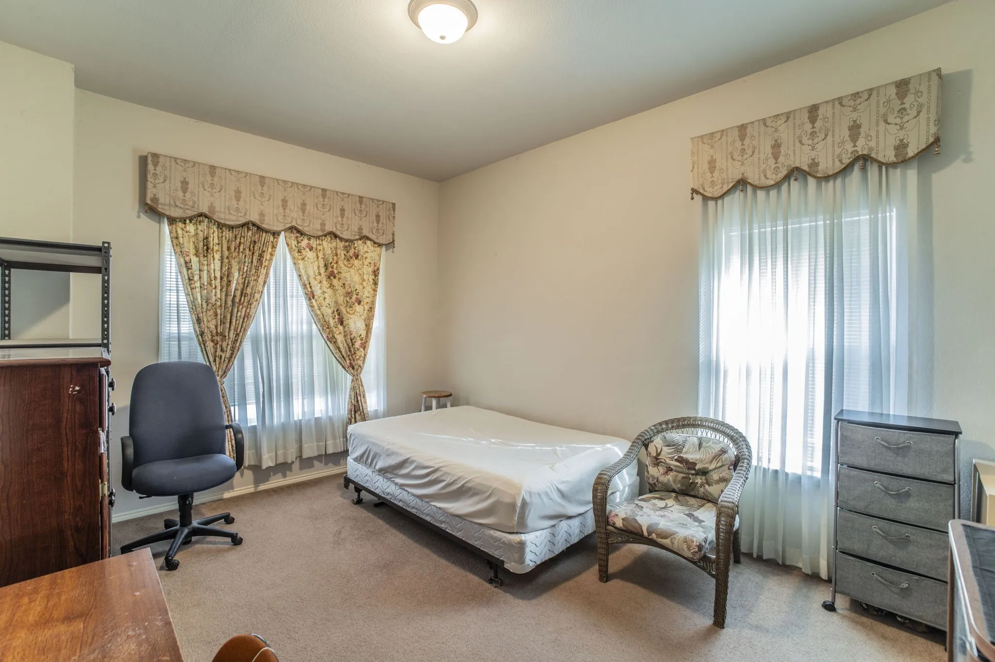 Bedroom featuring carpet and multiple windows