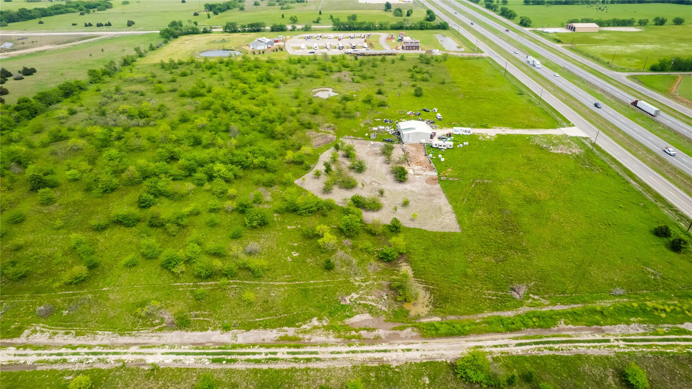 Aerial view of sparsely populated area featuring a major roadway