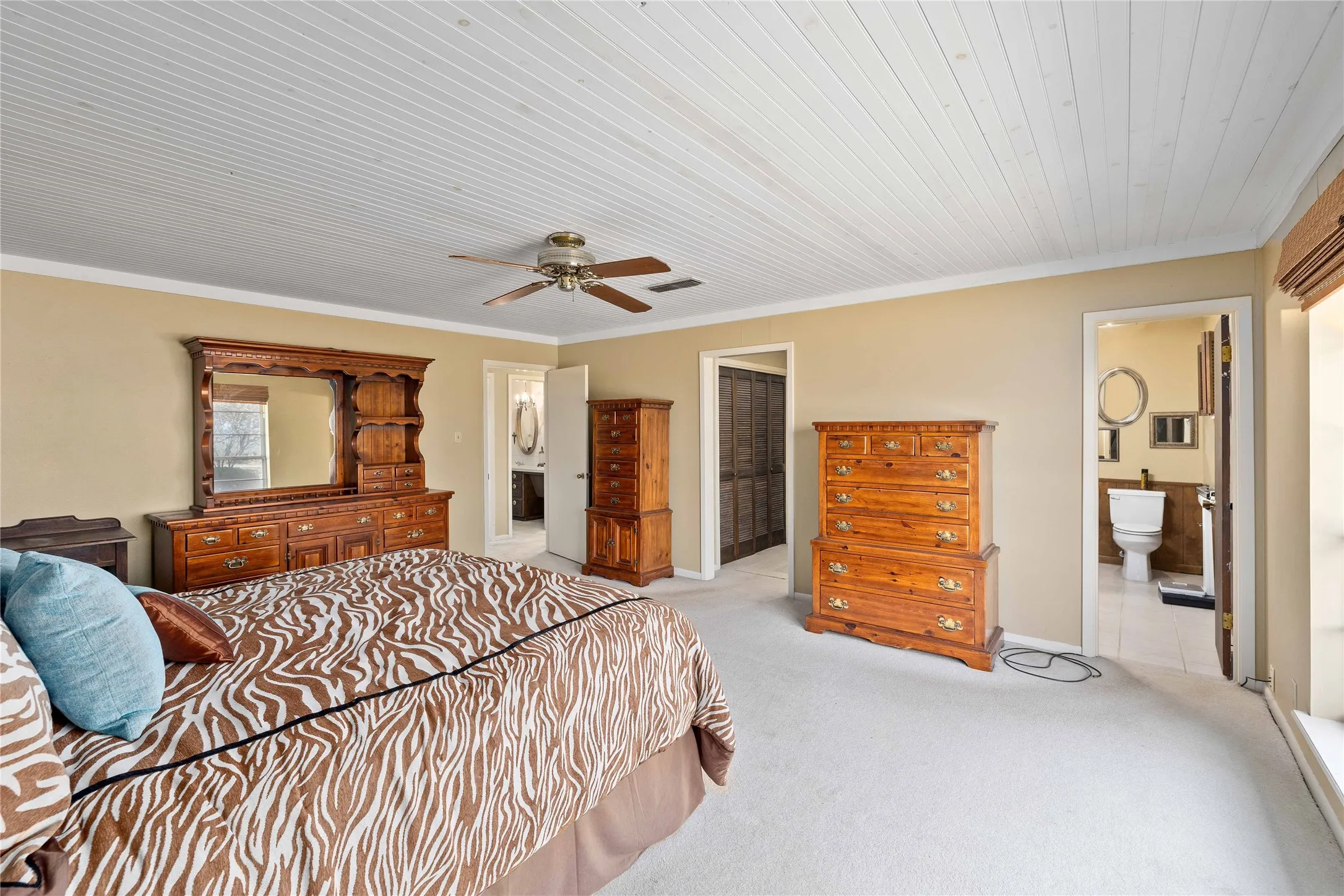 Primary bedroom with large windows on rear of home