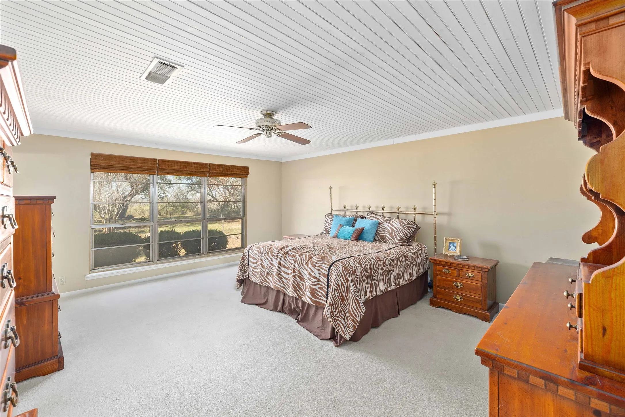 Primary bedroom with large windows on rear of home