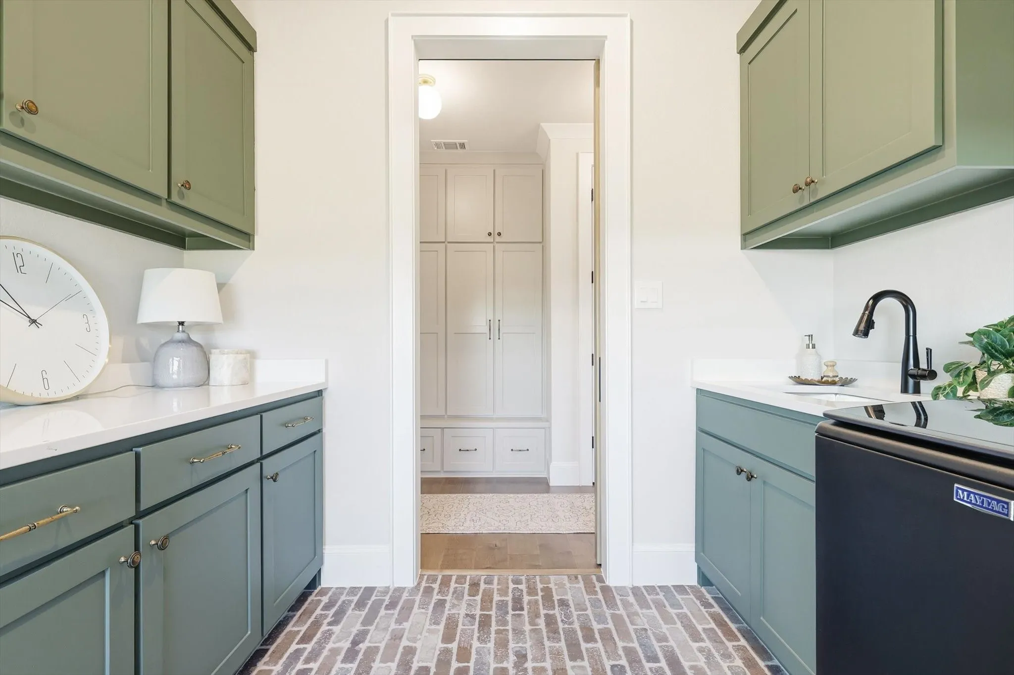 Laundry room with closet to left. Beautiful brick floor