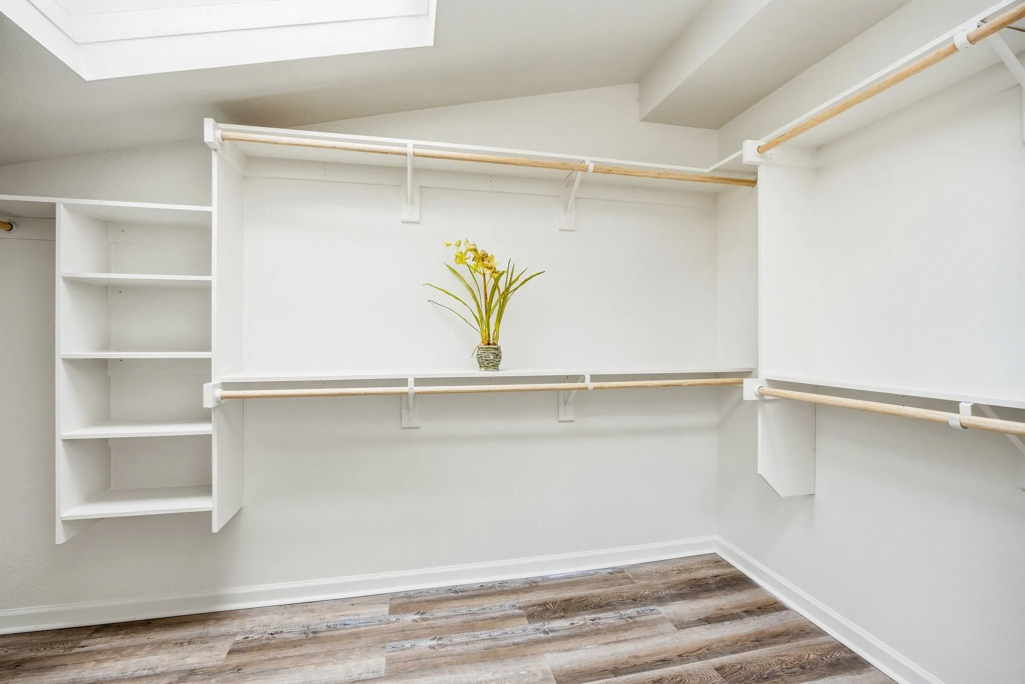 Spacious closet featuring vaulted ceiling and light wood-style flooring