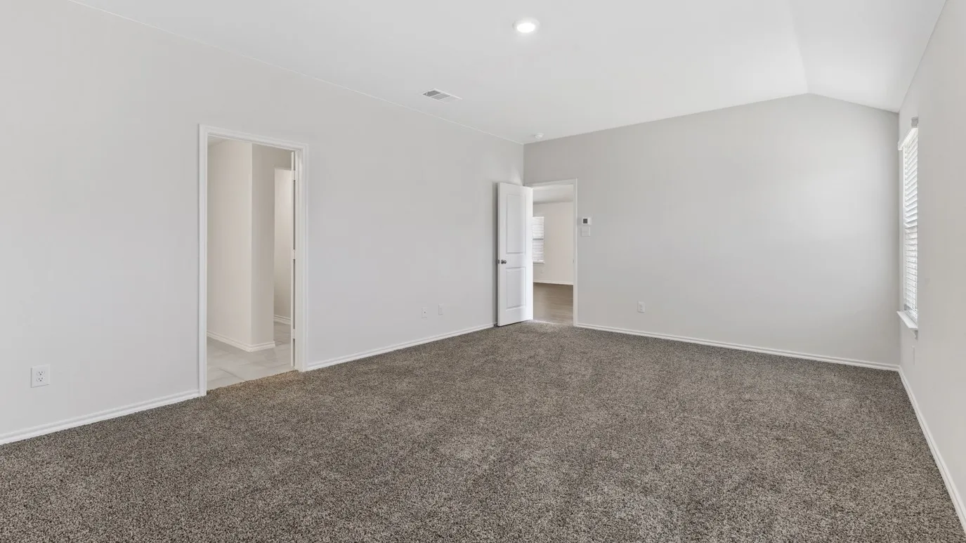 Unfurnished room featuring carpet flooring and lofted ceiling