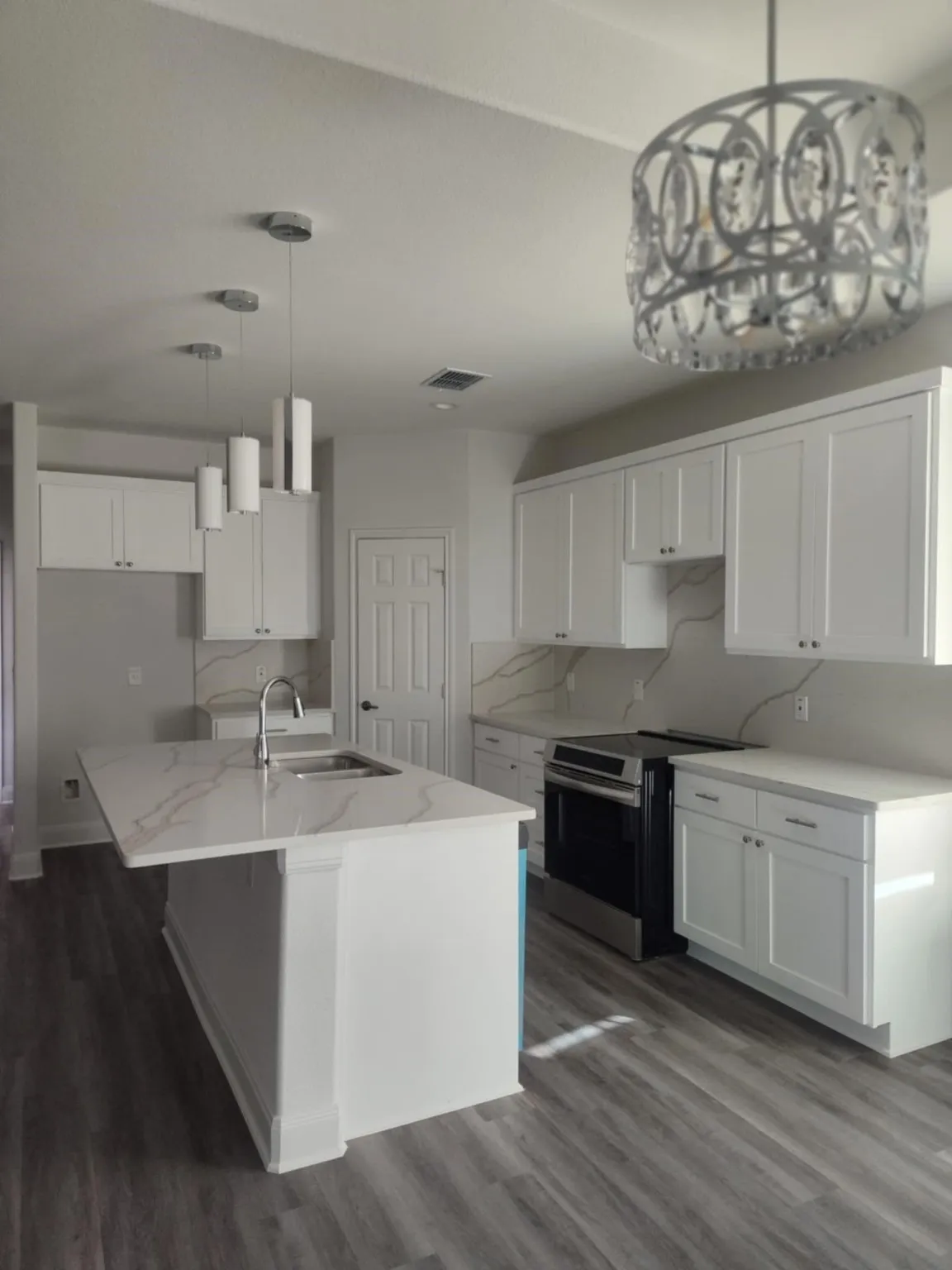 Kitchen featuring pendant lighting, white cabinets, stainless steel electric range, and dark wood-style flooring