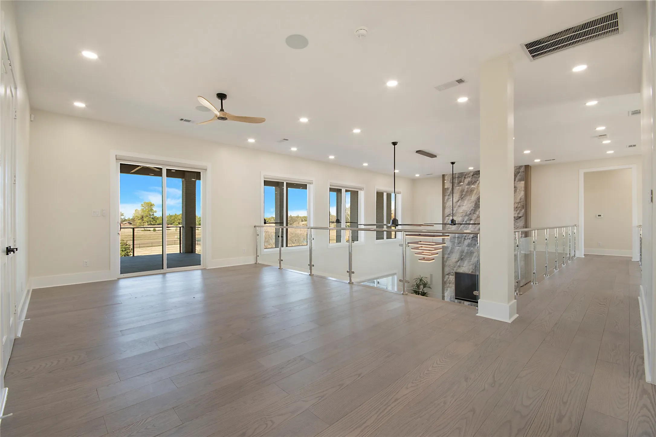 Unfurnished living room with a ceiling fan, light wood-type flooring, recessed lighting, and a fireplace