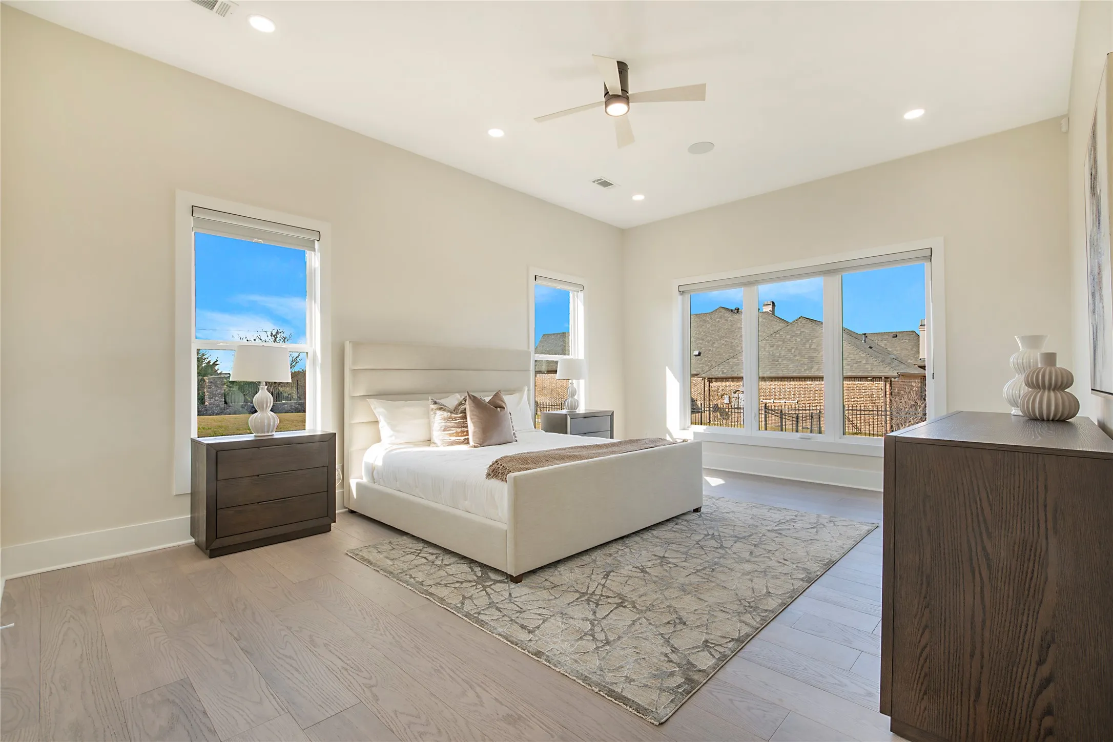 Bedroom featuring light wood-type flooring, a ceiling fan, and recessed lighting