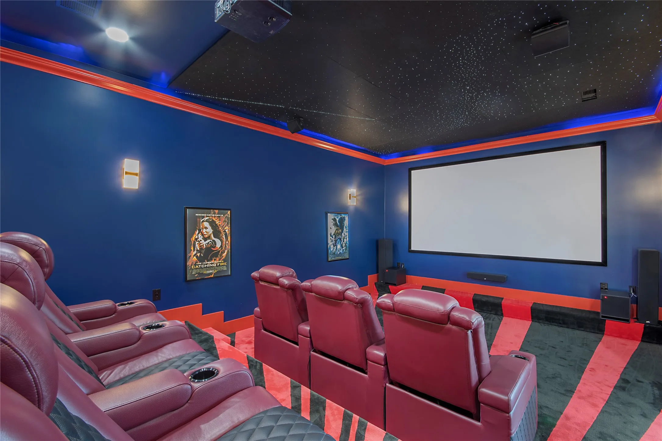 Carpeted home theater room with ornamental molding