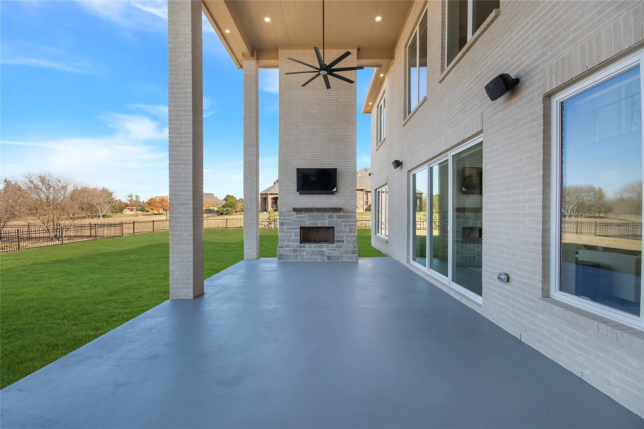 View of patio / terrace with a large fireplace and ceiling fan