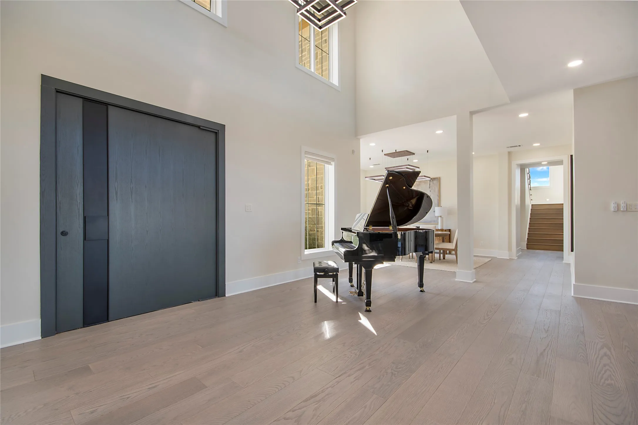Entryway featuring recessed lighting, wood finished floors, and a high ceiling
